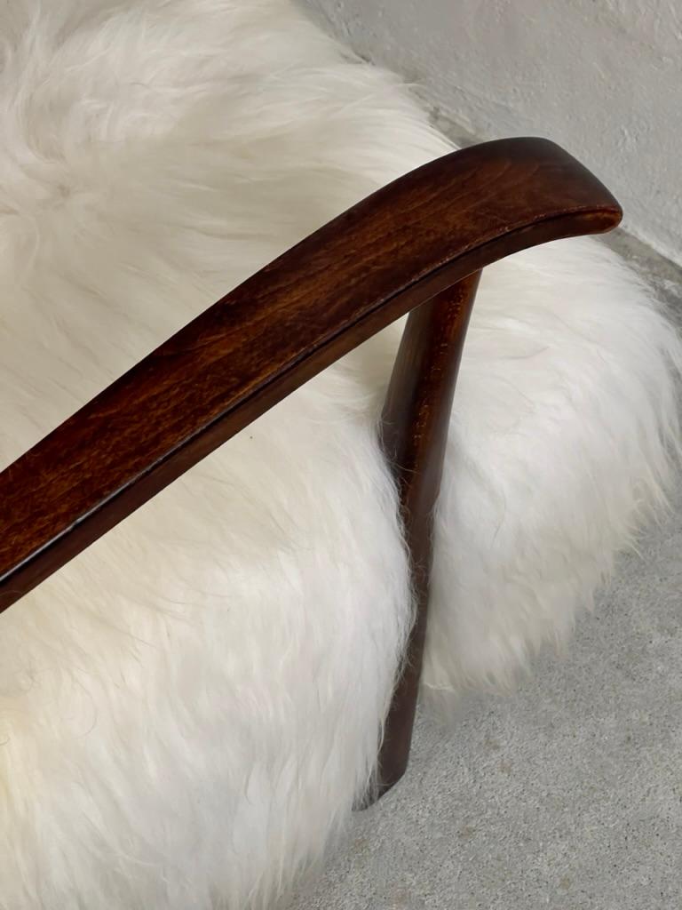 Stained 1940s Fritz Hansen Easy Chair Reupholstered in long haired Icelandic Sheepskin. For Sale