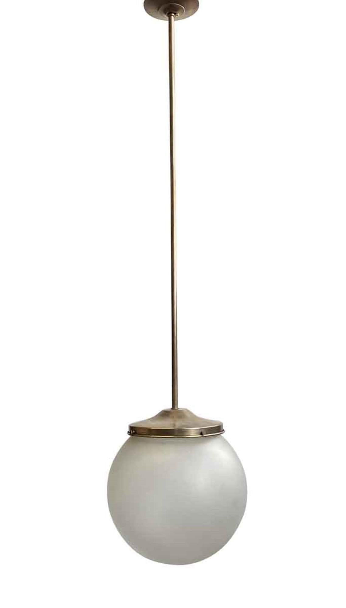 1940s frosted glass globe, new antique brass finished hardware. Can also be made with nickel finish hardware. Cleaned and rewired. Small quantity available at time of posting. Priced each. Please inquire. Please note, this item is located in our