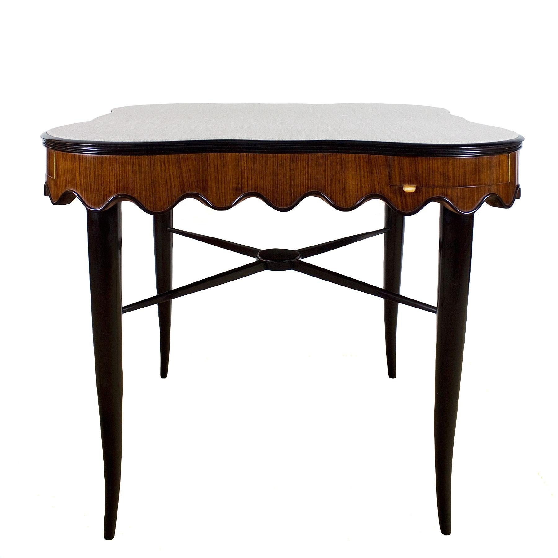 Charming game table, solid stained mahogany stands with crossbar, mahogany undulating ring base, corner drawers with brass handles, French polish. Gray felt on top (could be changed),

Italy, circa 1940.