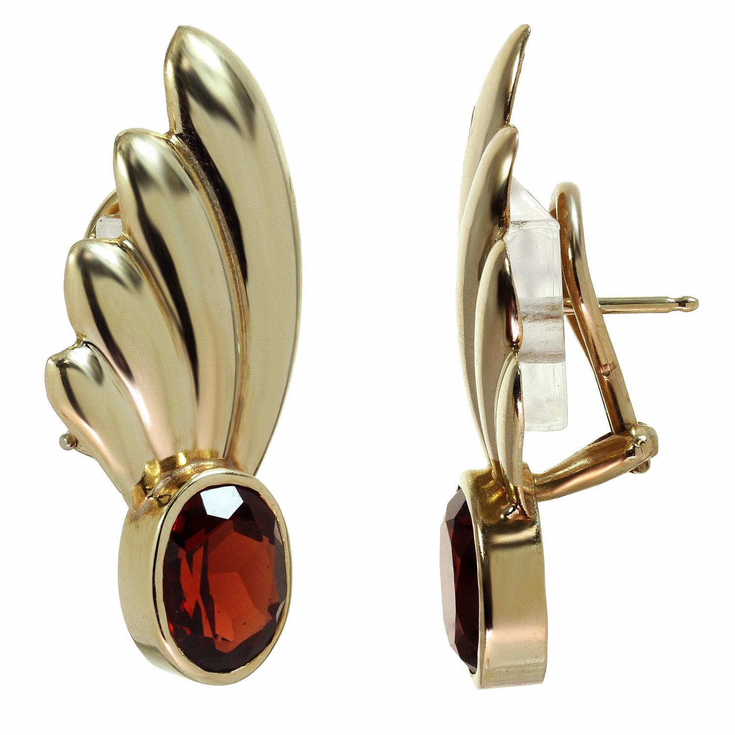 These fabulous retro lever-back earrings feature a fan-shaped design crafted in 14 yellow gold and set with oval red garnets. Made in United States circa 1940s. Measurements: 0.59