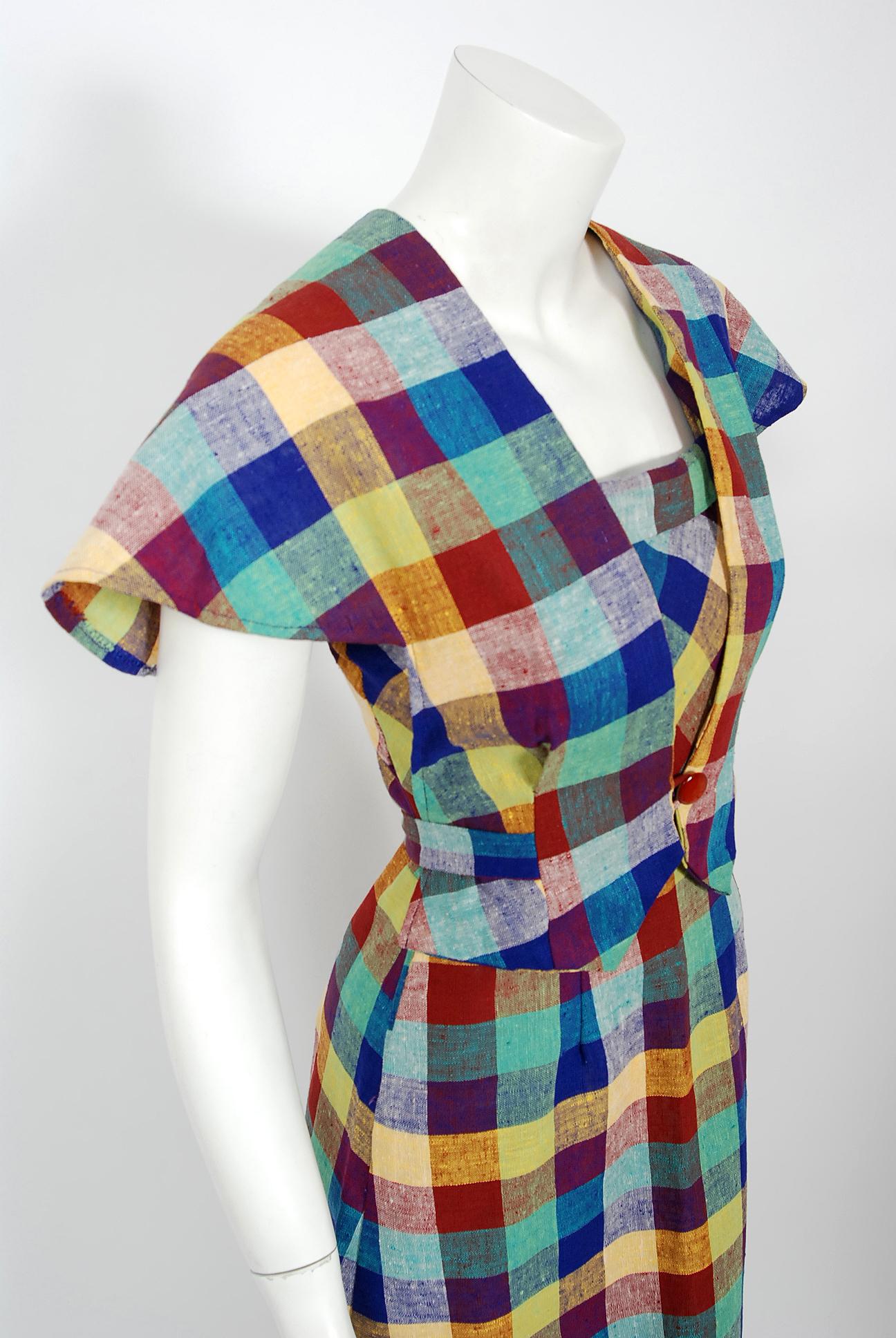 With its vibrant linen-cotton plaid and flawless styling, this Gay Gibson designer dress ensemble has the casual elegance the 1940's were known for. The tri-strap bodice with side buttons is very flattering and effortless to wear. The hourglass