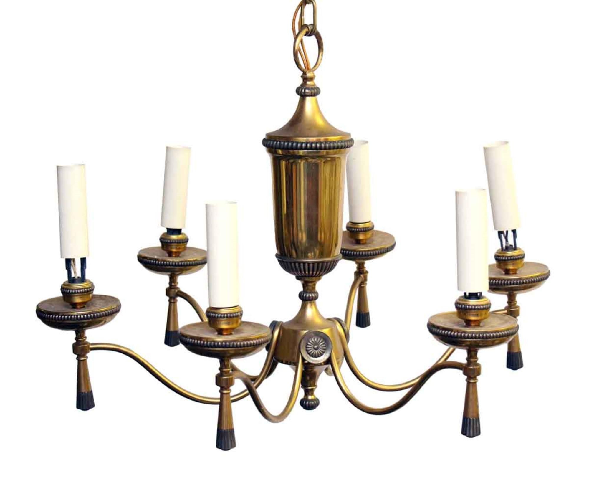 1940s Georgian style brass chandelier with beaded rosette detail and bottom tassels. Price includes restoration. Please allow 1-2 weeks to process. Please specify the overall drop that is needed upon purchasing. This can be seen at our 302 Bowery