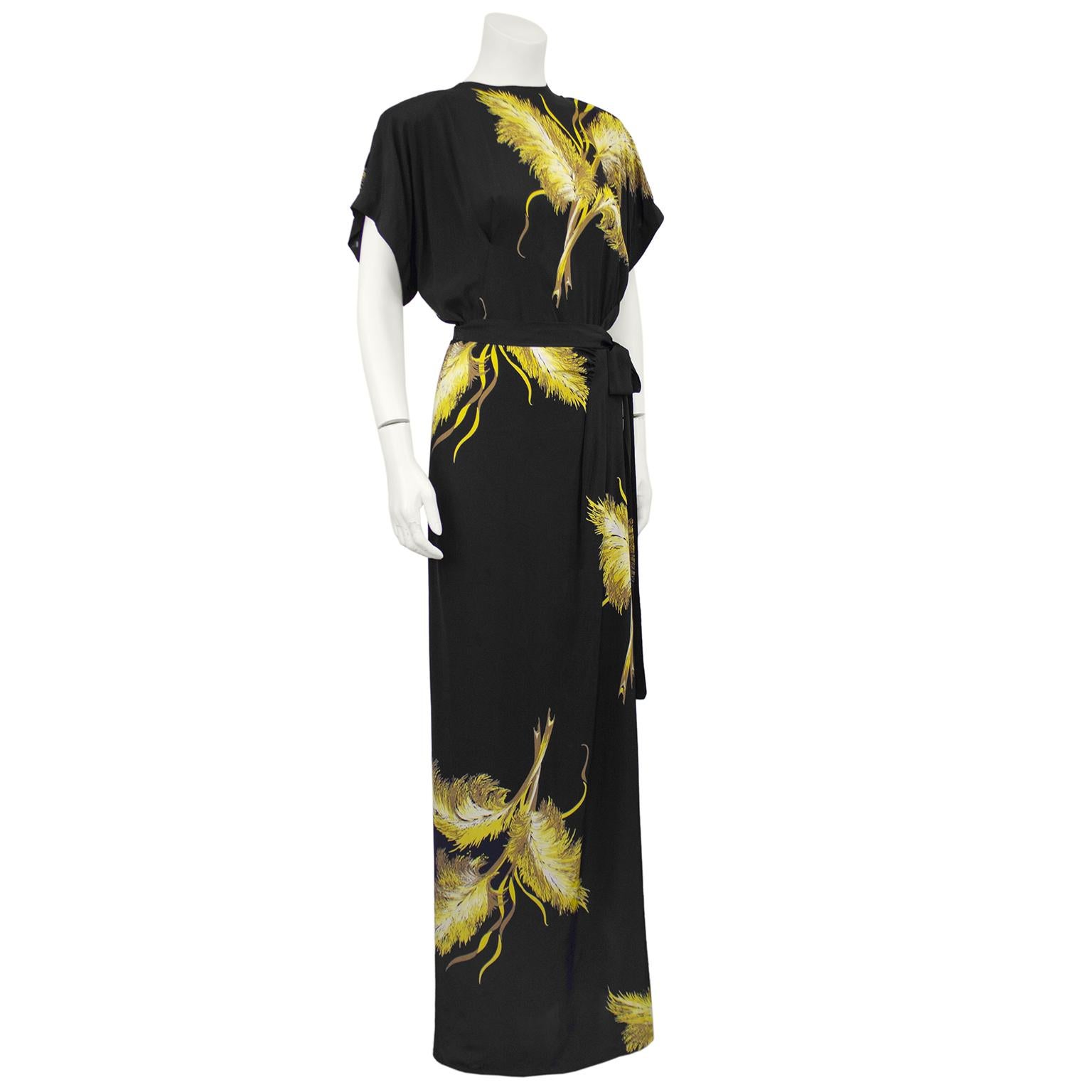 Very beautiful black silk maxi dress with all over large yellow and gold wheat sheaf print dates from the 1940s and was clearly inspired by both Schiaparelli in its long lean silhouette and Gilbert Adrians popular day/dinner dresses featuring