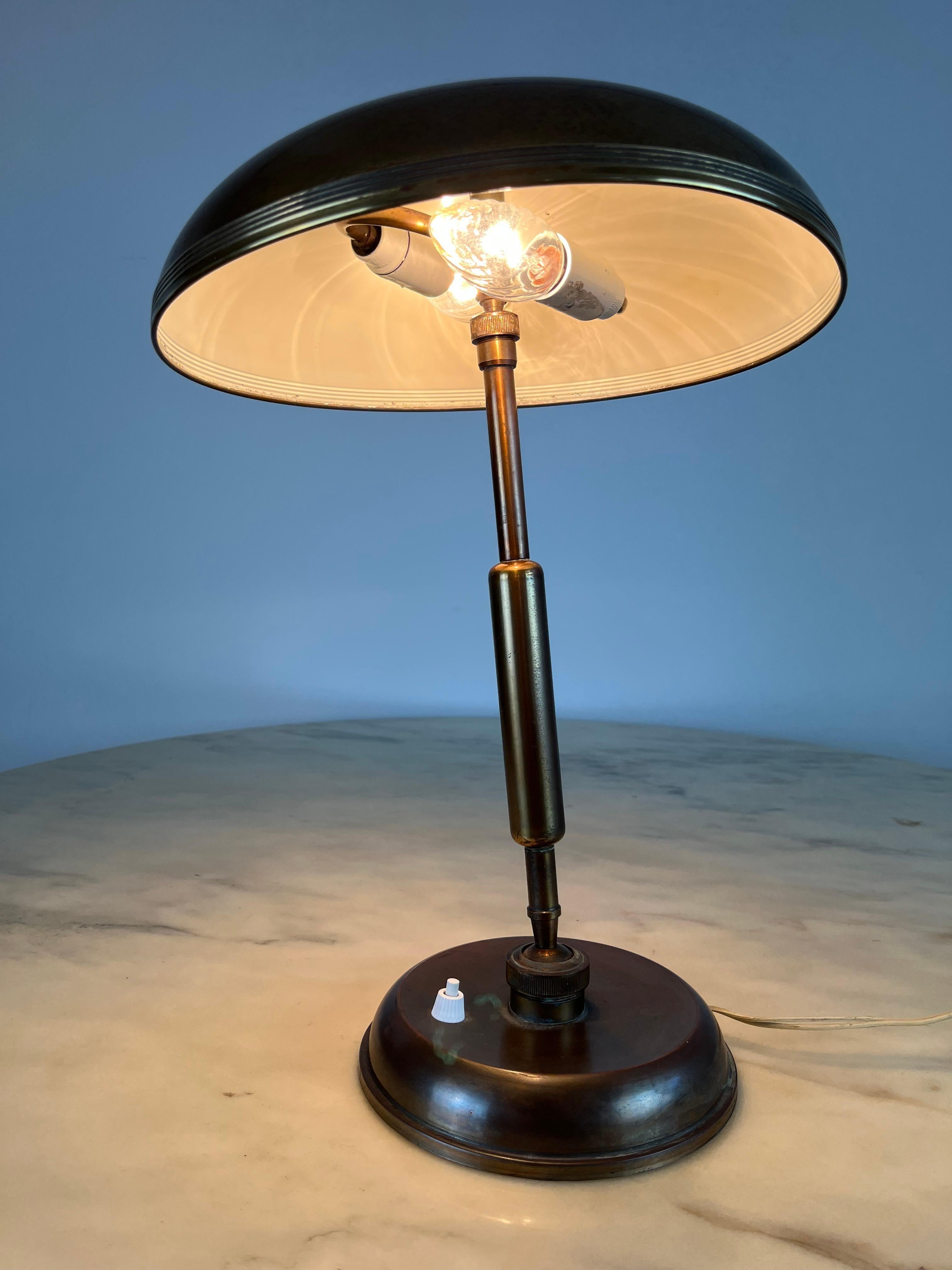 Pre-war Italian brass desk lamp, circa 1940s. A Classic desk lamp which combines the characteristics of the Art Deco and Art Nouveau movements. A Lariolux ministeriale rounded shade tops an adjustable brass support stem. The brass features a