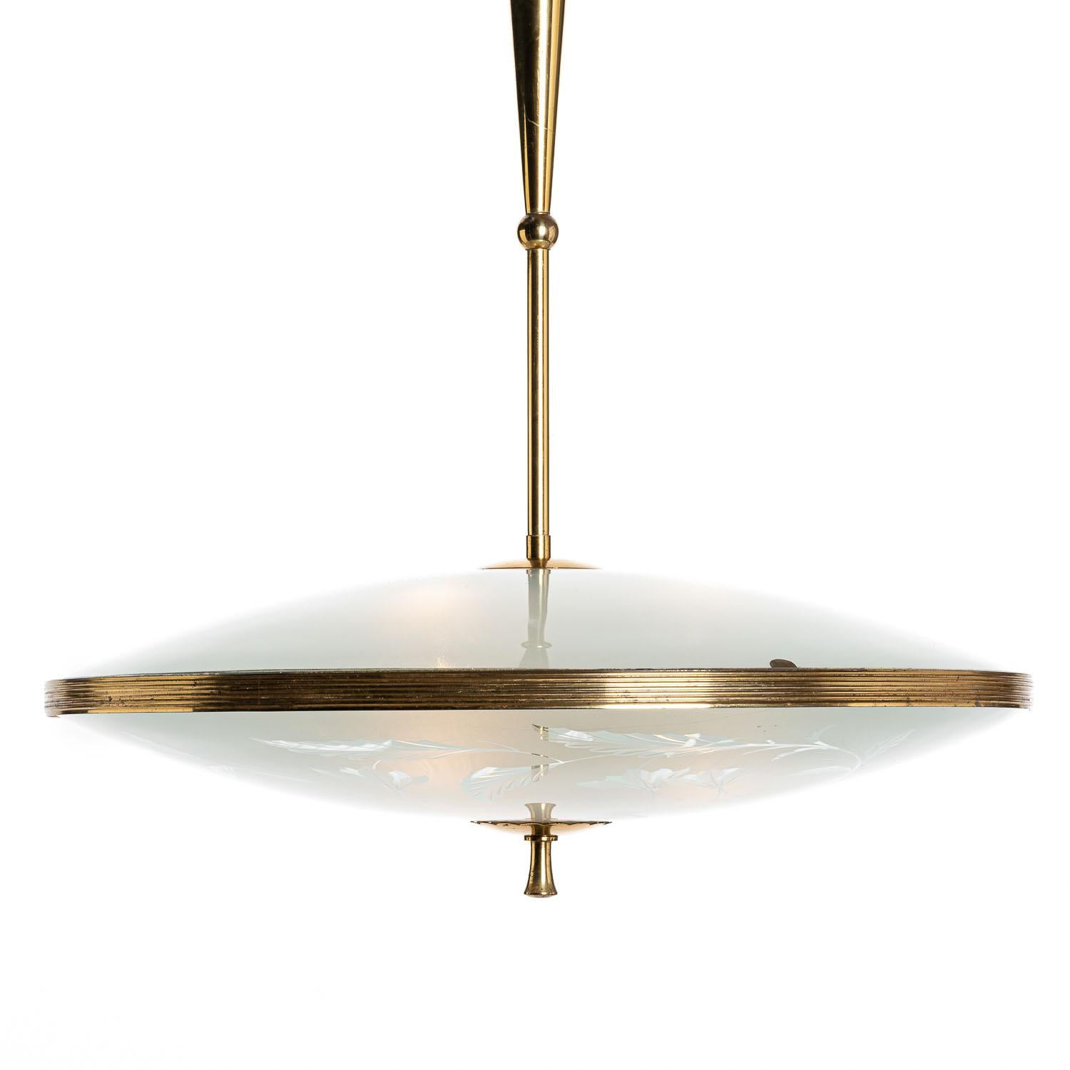 This large elegant piece consisting of a brass frame and 2 unique frosted and satin glass reflectors. 
The lower round curved glass reflector with floral motifs mounts below a round satin glass reflector. Finished off with a brass decorative ring.
