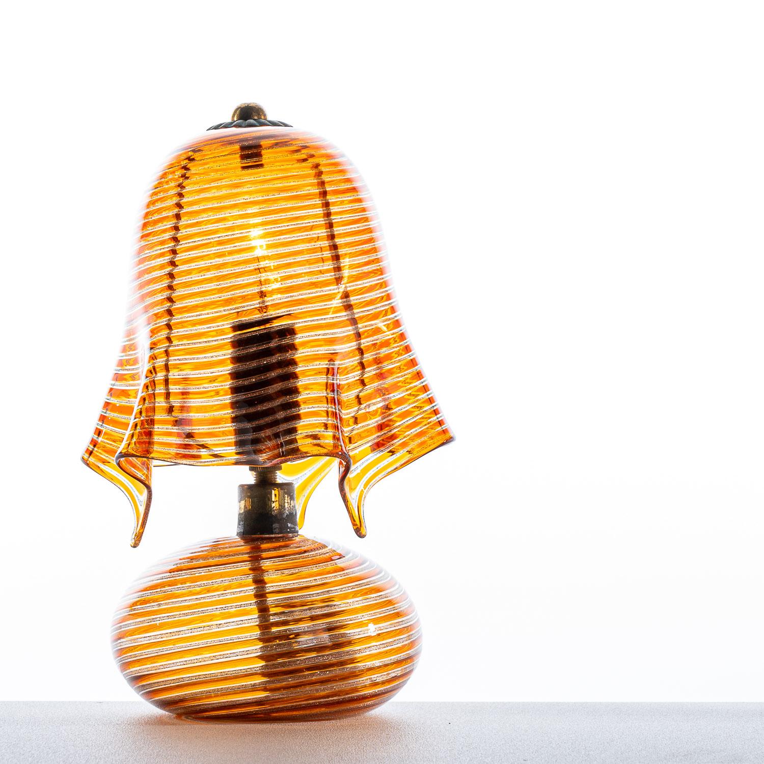 This unique piece comes from 1940s attributed to Italian designer Aureliano Toso. The sculpted transparent-amber shade flows elegantly, giving an almost material-like appearance. This unique lamp will catch the eye in any room and looks incredible