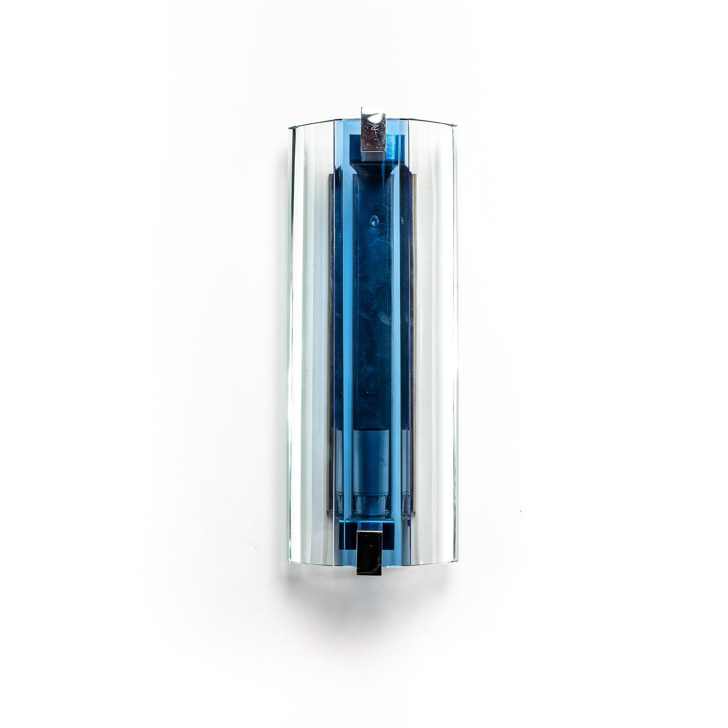 This original Veca set brings a design edge to any space. The brass and chrome combination feels modern and sharp, and this is emphasized by the blue glass cover. These lights are in great condition and come with their original Veca stickers.