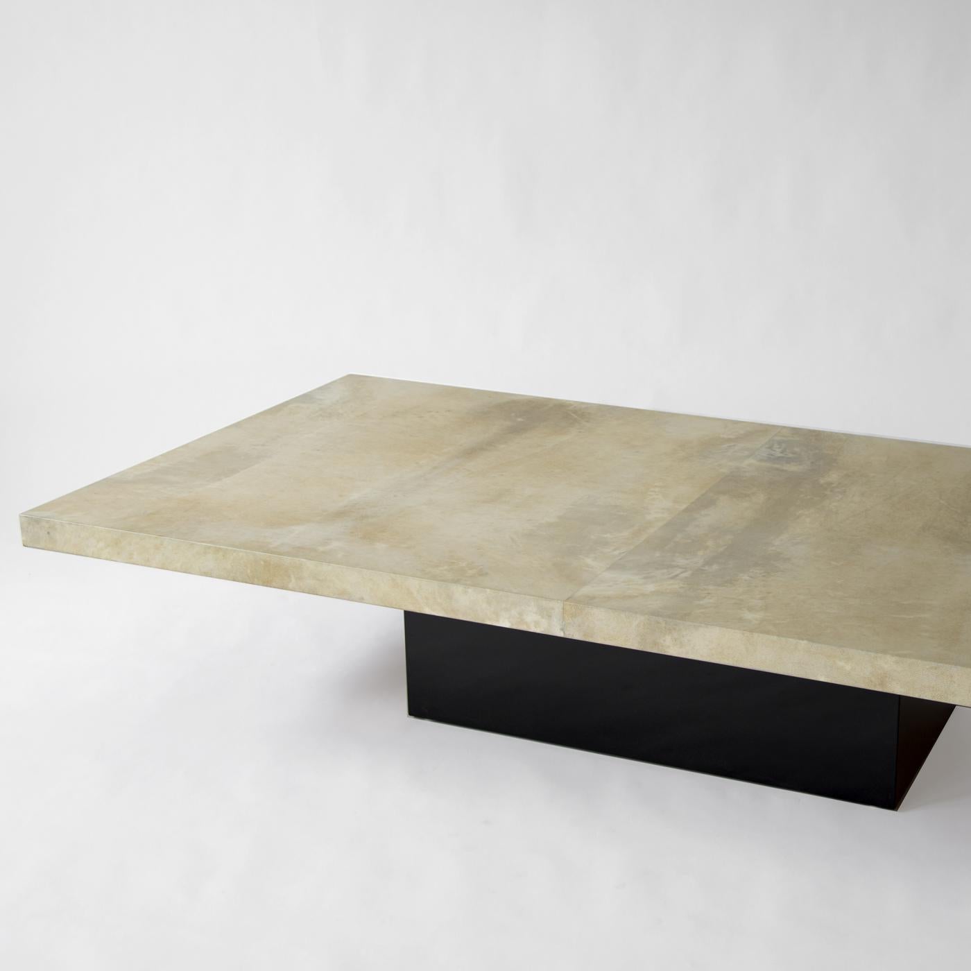This modern and stylish goatskin coffee table features a top in original natural parchment with a matte finish. The sturdy base has been modernized and lacquered black and combines with the spectacular top to make it an elegant and unique piece that