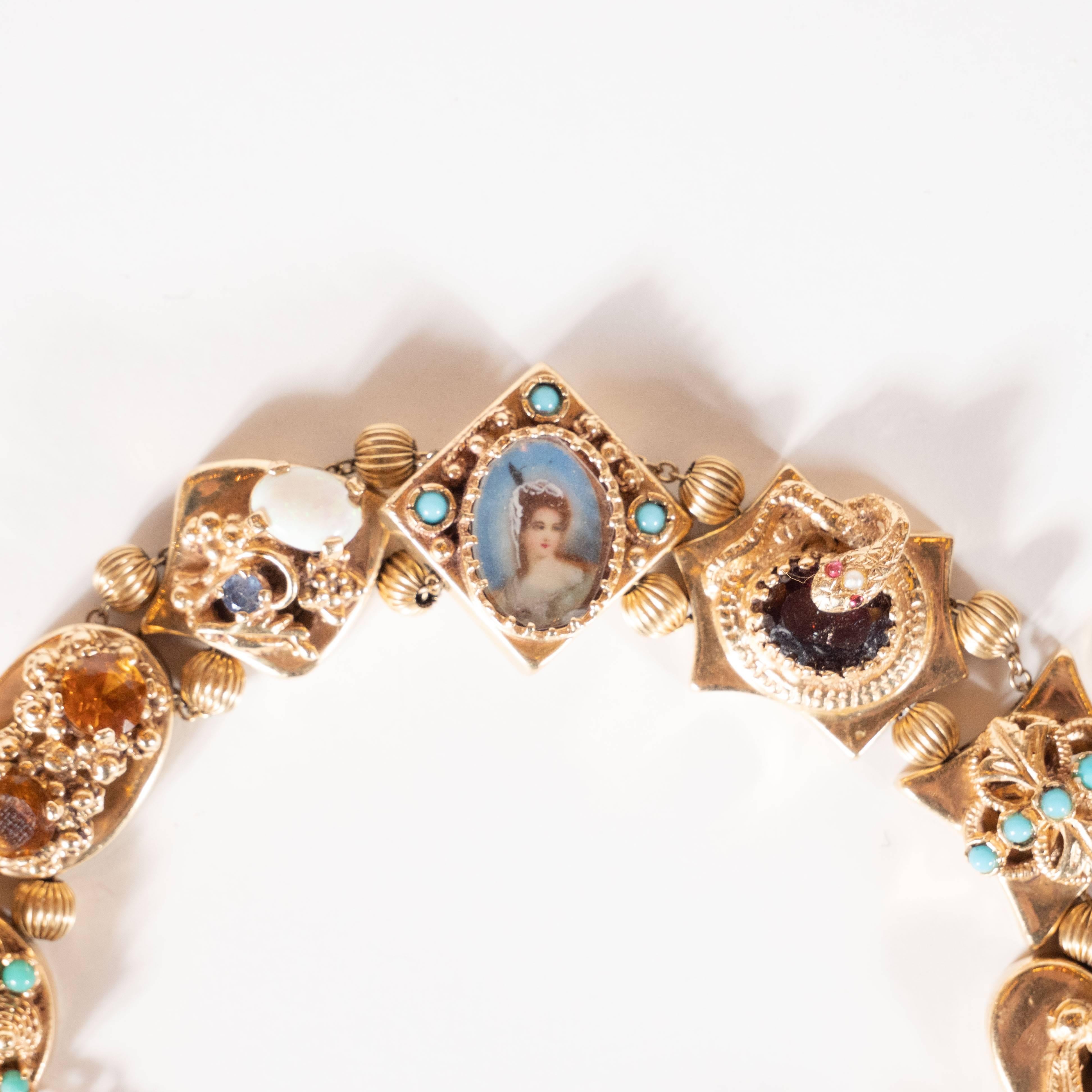 This stunning and elegant slide bracelet was realized in the United States, circa 1940. It features eight charms realized in 14kt gold. There is a square clasp connected to the first beed by two fluted orbs in 14kt gold. The first charm features six