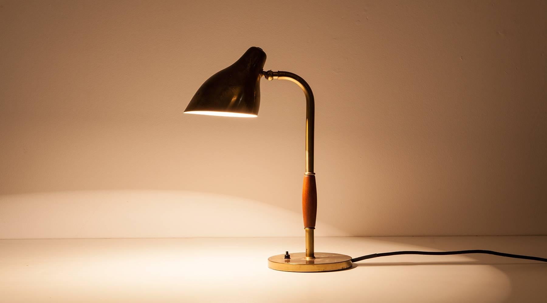 Vilhelm Lauritzen table lamp with adjustable shade from 1948. Slightly curved conical shade. Stem partly covered with teak. Lamp is in a very good condition with a lovely patina. Manufactured by Louis Poulsen.

Vilhelm Lauritzen is one of the most