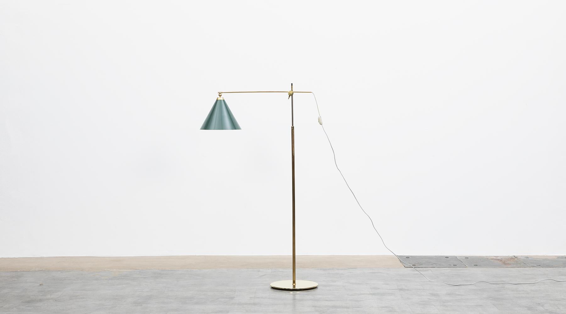 Lacquered green metal shadow, brass stem and base by Kaare Klint, Denmark, 1940.

Very unique floor lamp from the midcentury, designed by Kaare Klint. The lamps are made of brass and are adjustable in height and angle of the shade. Kaare Klint was