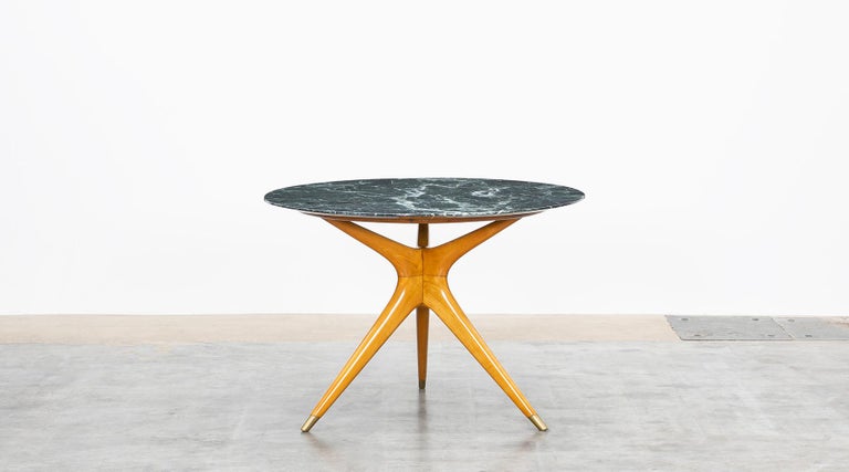 Beautifully worked table designed by Ico Parisi comes with round table top made of finest marble in green. The three legs are made of wood and finish on brass. Manufactured by Ariberto Colombo.

The creative multitasker was not only one of the