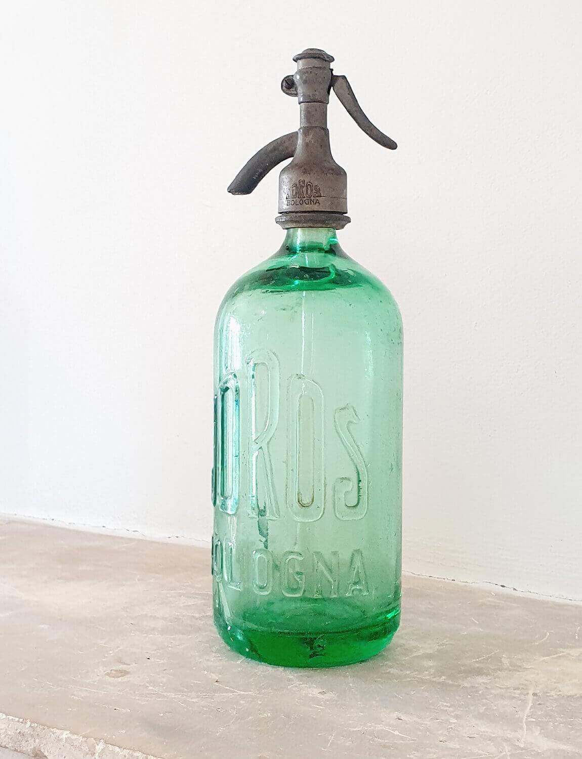Rare beautiful green soda bottle with the words Joros Bologna in raised lettering on the bottle. This is a beautiful piece but there is a large internal crack in the glass which is reflected in the price. It is so pretty that as a display piece I