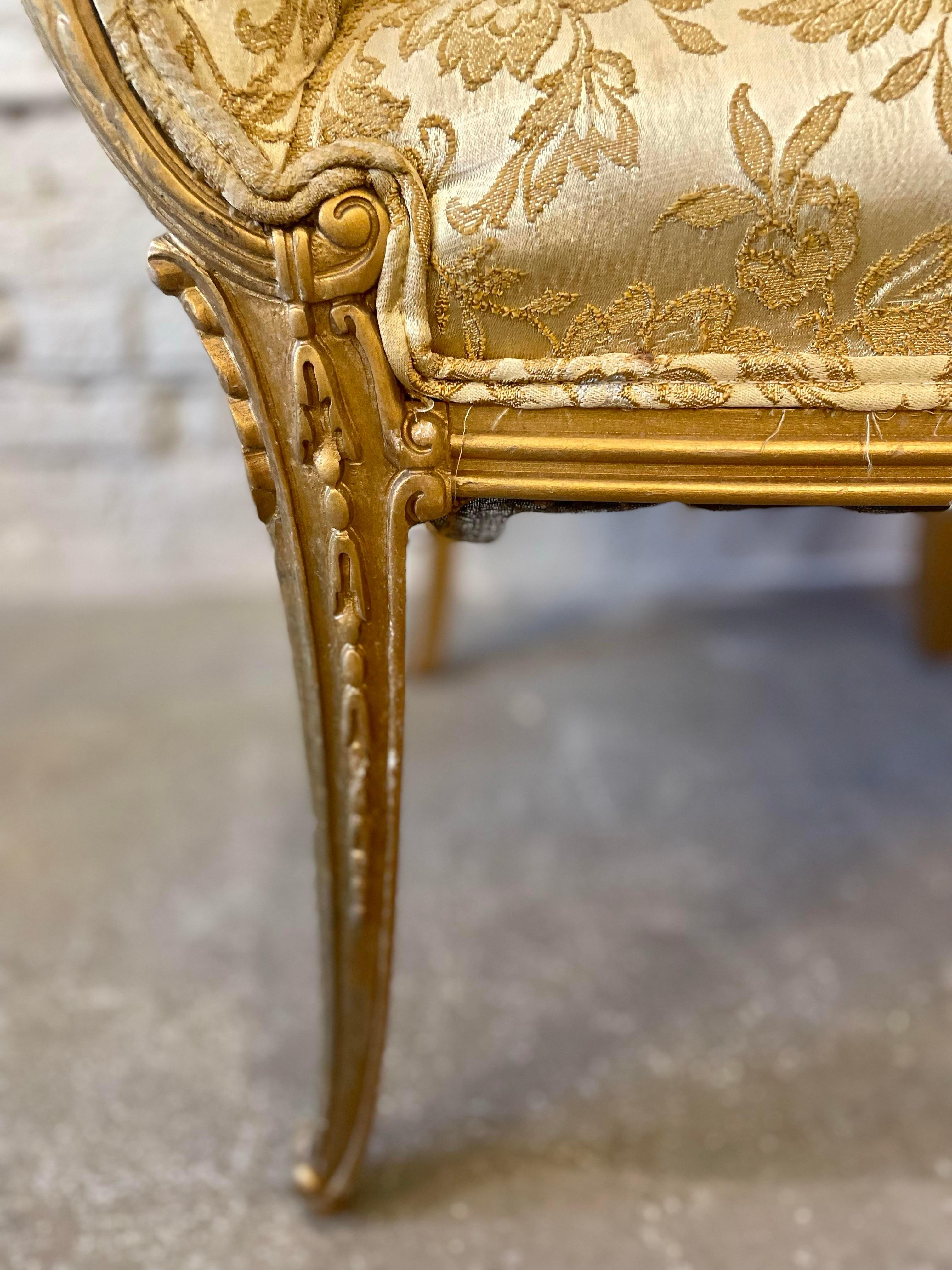 Stunning pair of chairs that are actually comfortable too. The gold gilt wood is in excellent condition as is the foam/springs/fabric. Use as is or redo as you like:) 

DIMENSIONS: 28ʺW × 24ʺD × 42ʺH  
STYLES: Hollywood Regency  
NUMBER OF SEATS: 2 