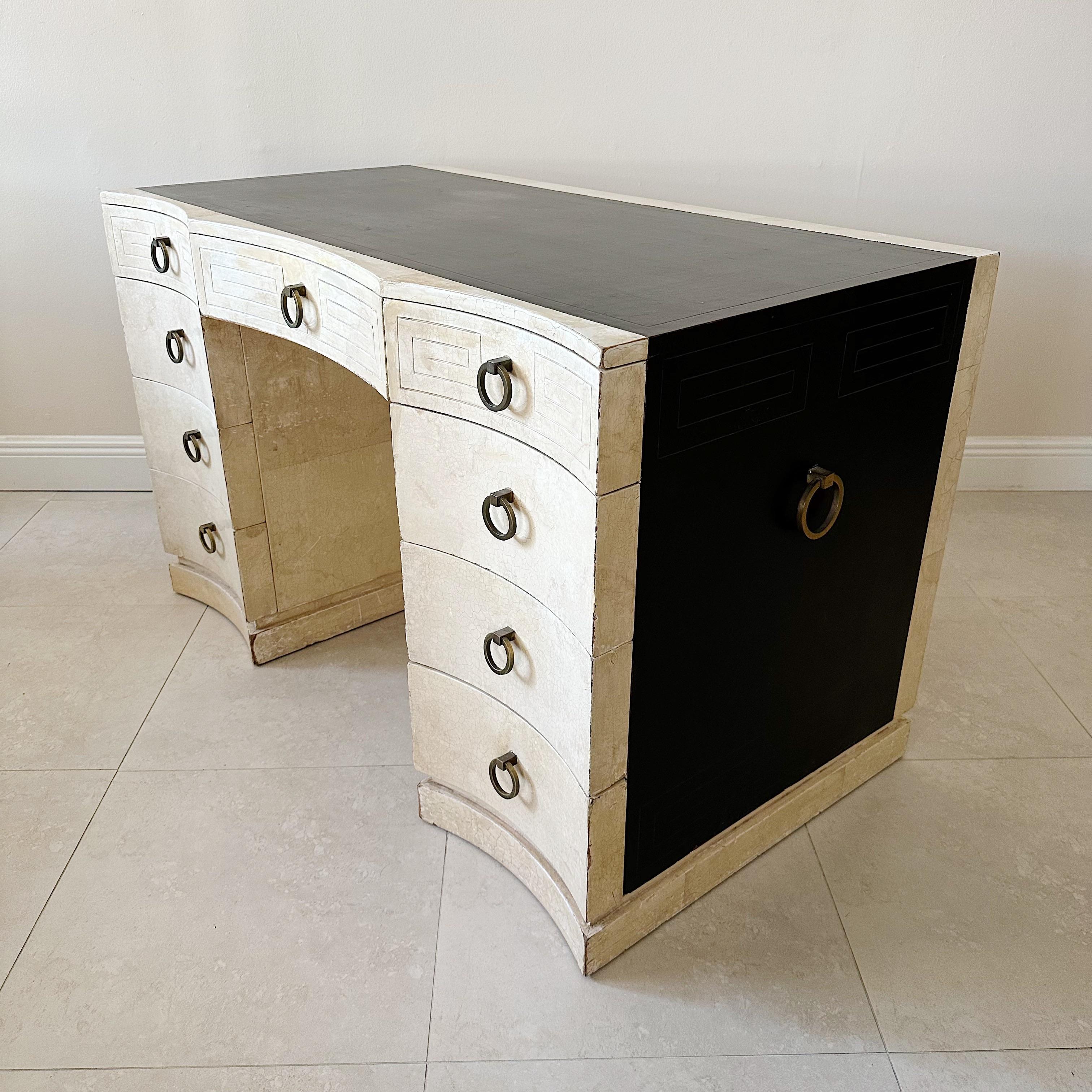 1940's Grosfeld house desk with nine drawers. This desk is finished on all sides with Greek key decoration . This is one of the pieces designed and/or selected by architect and designer Samuel Marx for the Plotkin-Dresner residence of Highland Park,