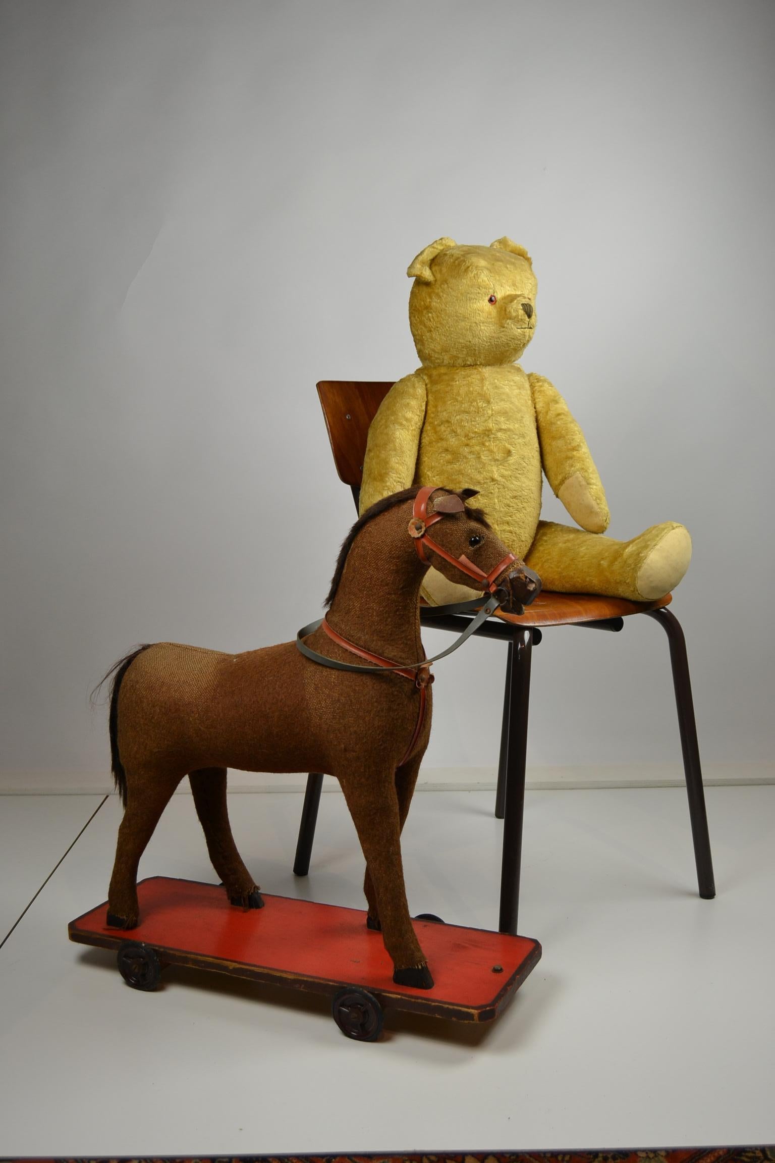 Cute large murmur bear toy filled with straw.
This vintage toy doll bear - teddy bear dates from the 1940-1950s,
has glass eyes, embroidered nose, movable arms, legs and head. 

Large bear: Standing: 31,10 inch - 79 cm H 
 Sitting: 22.04 inch -