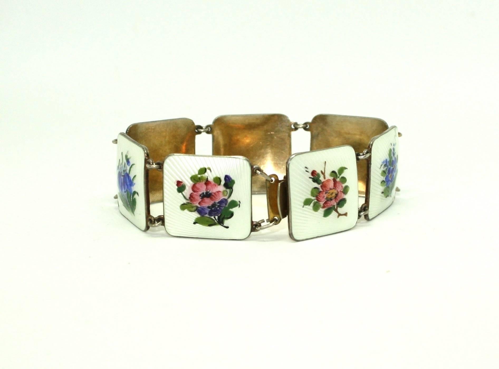 Beautiful guilloche enamel panel bracelet featuring hand painted flowers. The bracelet is hallmarked Norwegian Sterling Silver (925S) and is by Bernard Meldahl. The bracelet features a fully working box tongue clasp and is very easy to wear. 