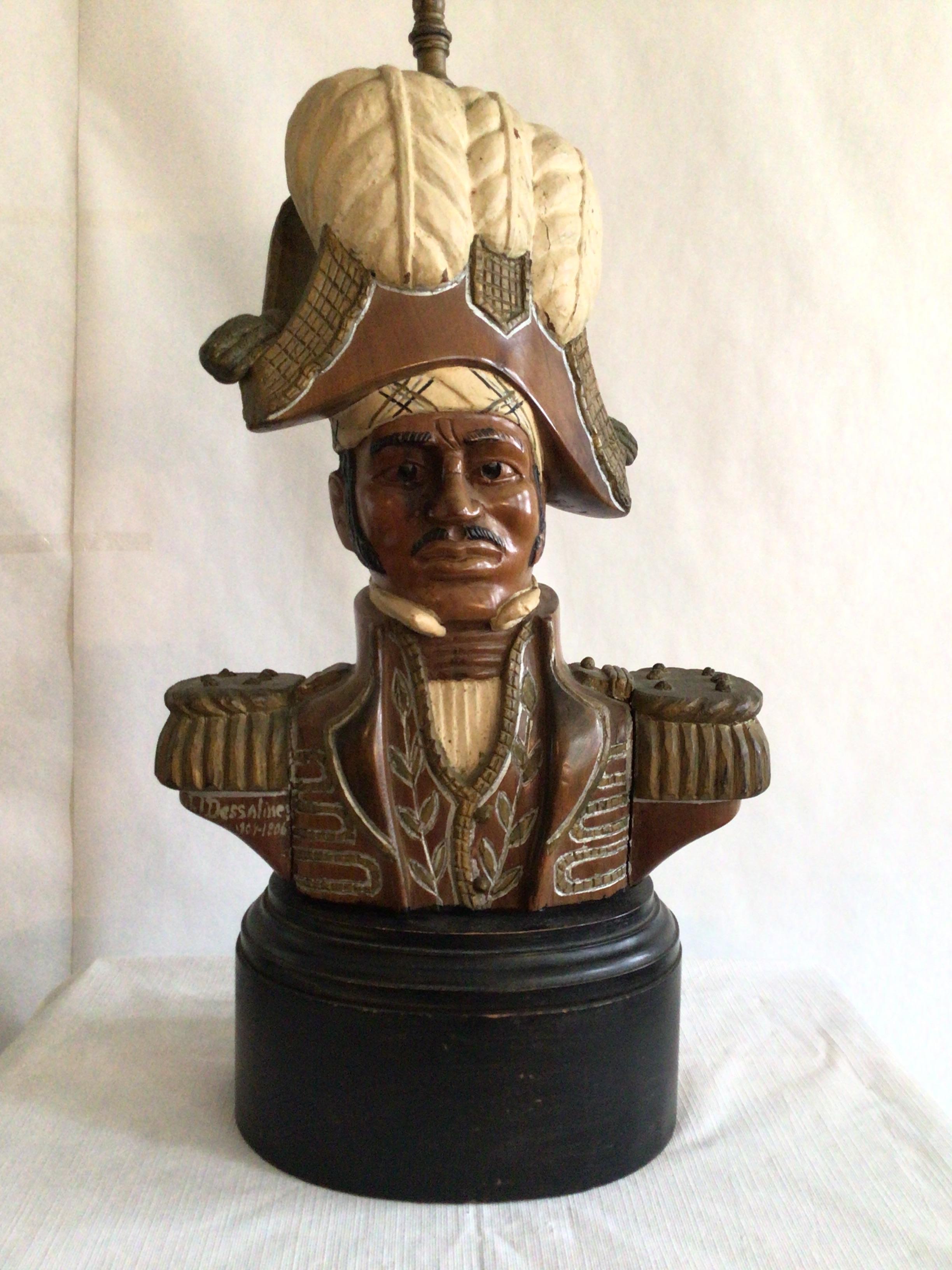 1940s hand carved and painted admiral table lamp
Signed JJDessaline 1804-1806 
Back* Ulysse Dabouze (sculpture name) Jérémie, Haiti 
All wood base 
Height to top of socket.