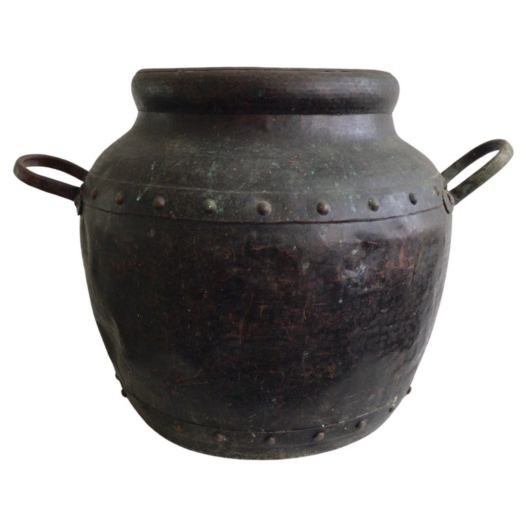 https://a.1stdibscdn.com/1940s-hand-hammered-studded-patinated-copper-pot-with-handles-for-sale/f_10782/f_353565521690054473255/f_35356552_1690054474259_bg_processed.jpg?width=768