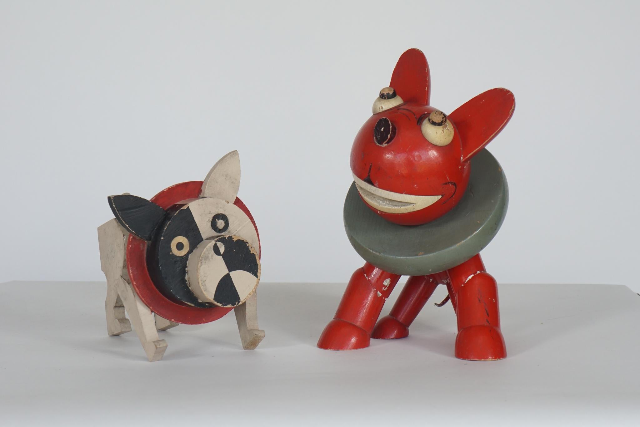 Wonderfully crafted collection of 5 painted toy dogs. Each one handcrafted and painted in a style reminiscent of the 1930s or 1940s round geometric designs with movable parts
A set of 5 but each 