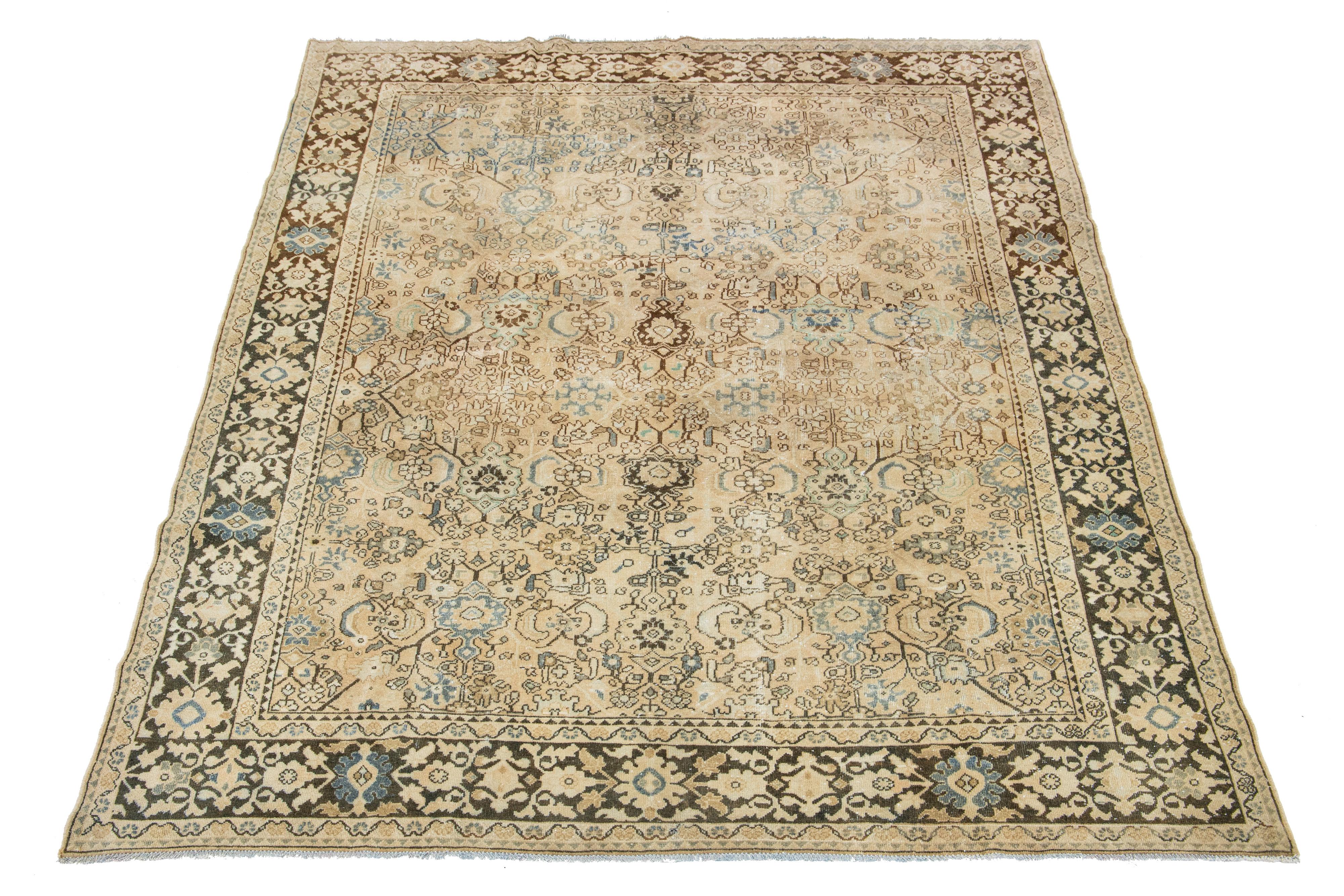 Beautiful Vintage Mahal hand-knotted wool rug with a beige color field. This Persian rug has blue and brown hues throughout the floral motif.

This rug measures 7'9