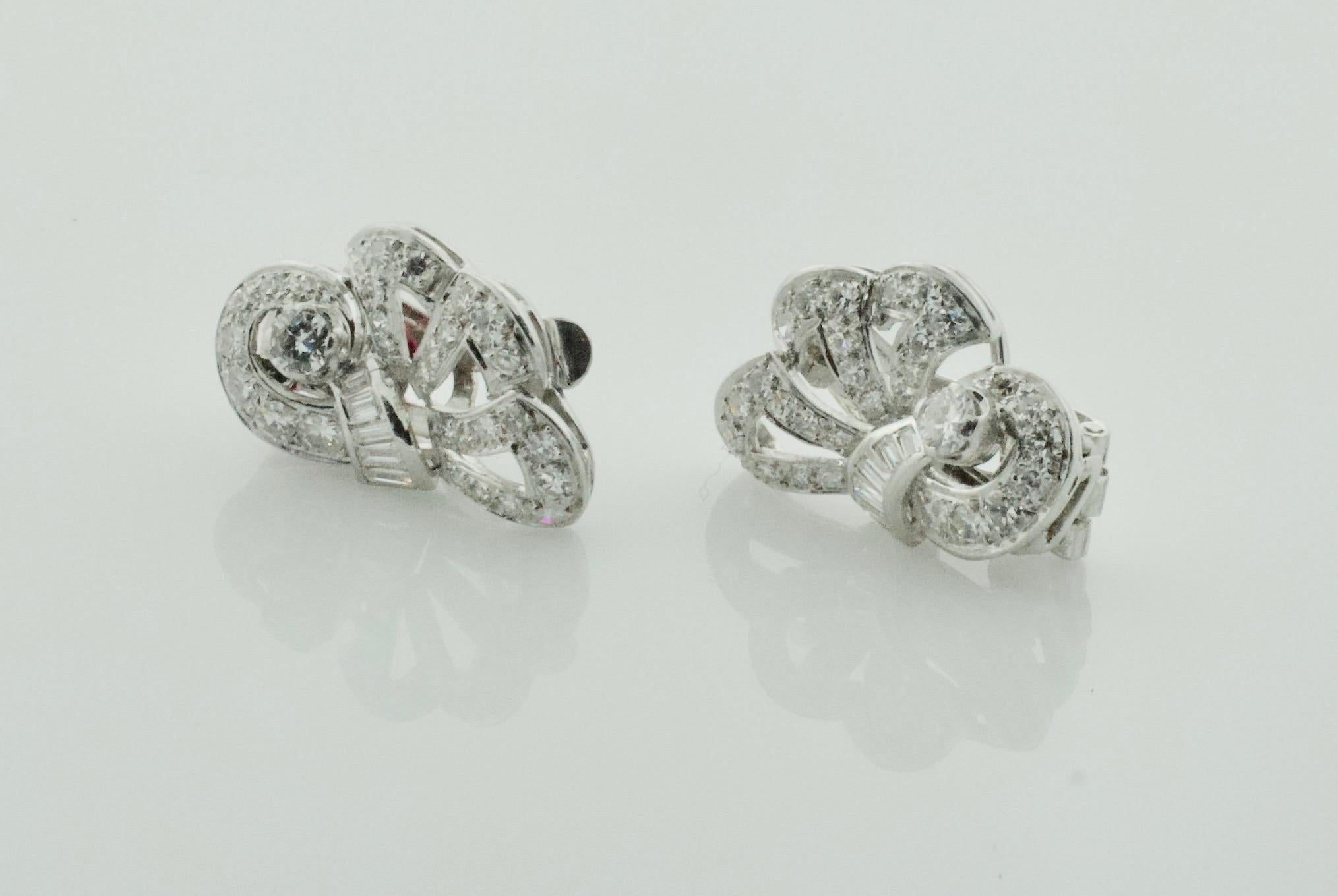 1940's Handmade Platinum Diamond Earrings  2.60 Carats 
Beautifully Made with a Left and Right Earring.  Which is which?  You decide.

Two Round Brilliant Cut Diamonds Weighing .30 Carats Approximately 
Ten Baguette Cut Diamonds Weighing .50 Carats