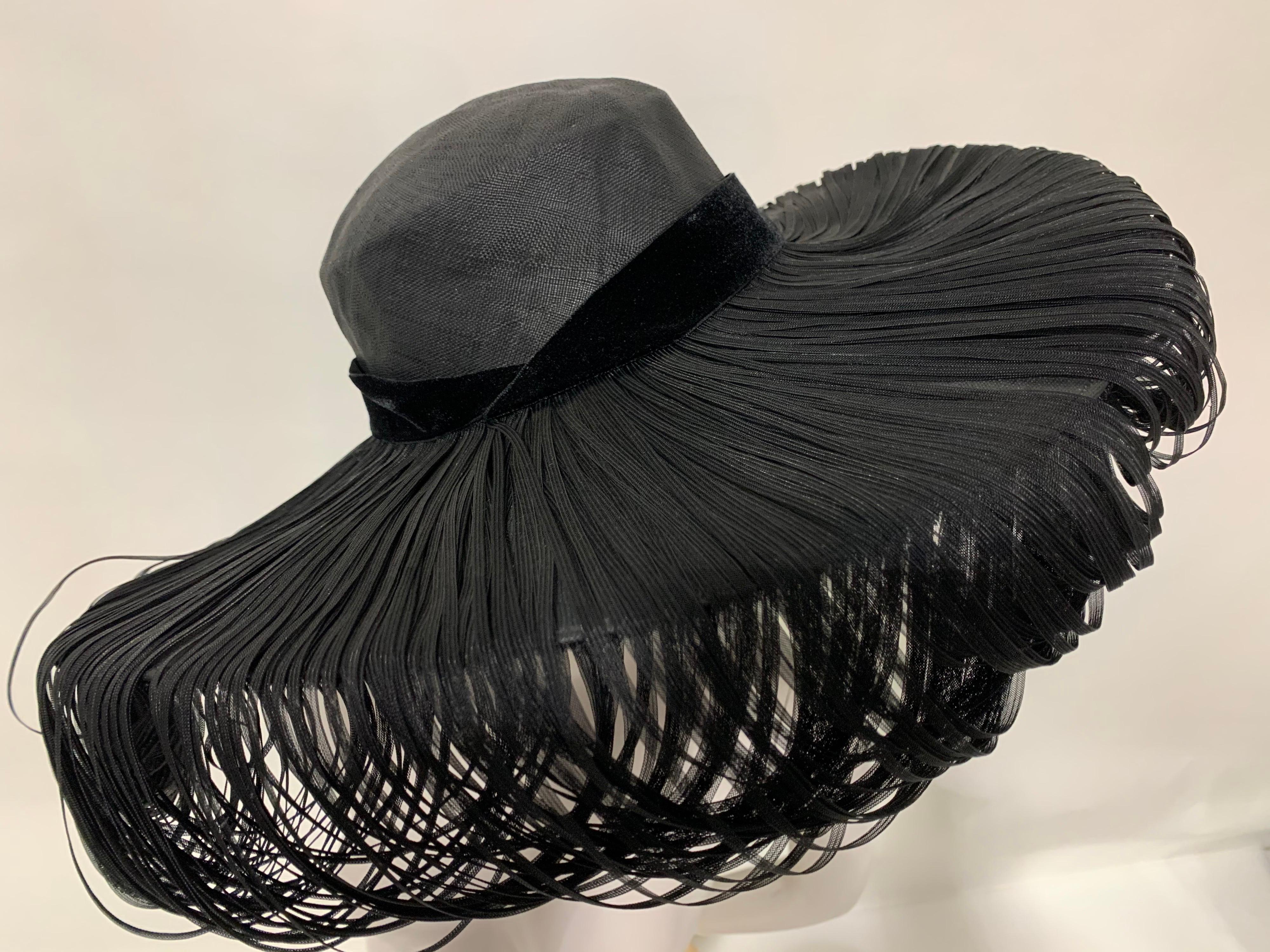 1940s Hattie Carnegie Fine Woven Black Straw Cartwheel Hat with Extravagant Loops. A spectacular and dramatic large brim straw hat with an unusual decorative treatment of draped, woven straw over entire brim. Black velvet banded. A rare sample of