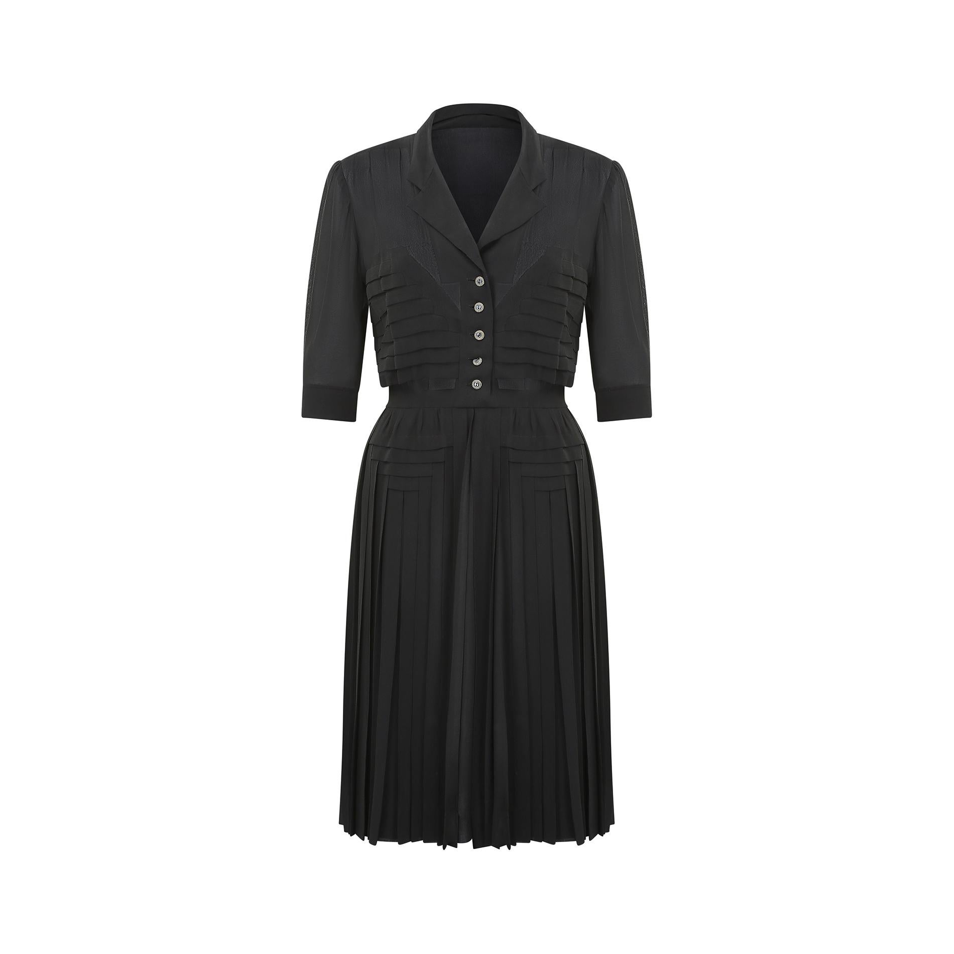 Superb French haute couture black silk dress and almost certainly made during or just after WWII - 1939-1947.  It has a V-neck collar, with subtle notching, and fastens at the left hand side with a column of six poppers and two hook and eyes at the