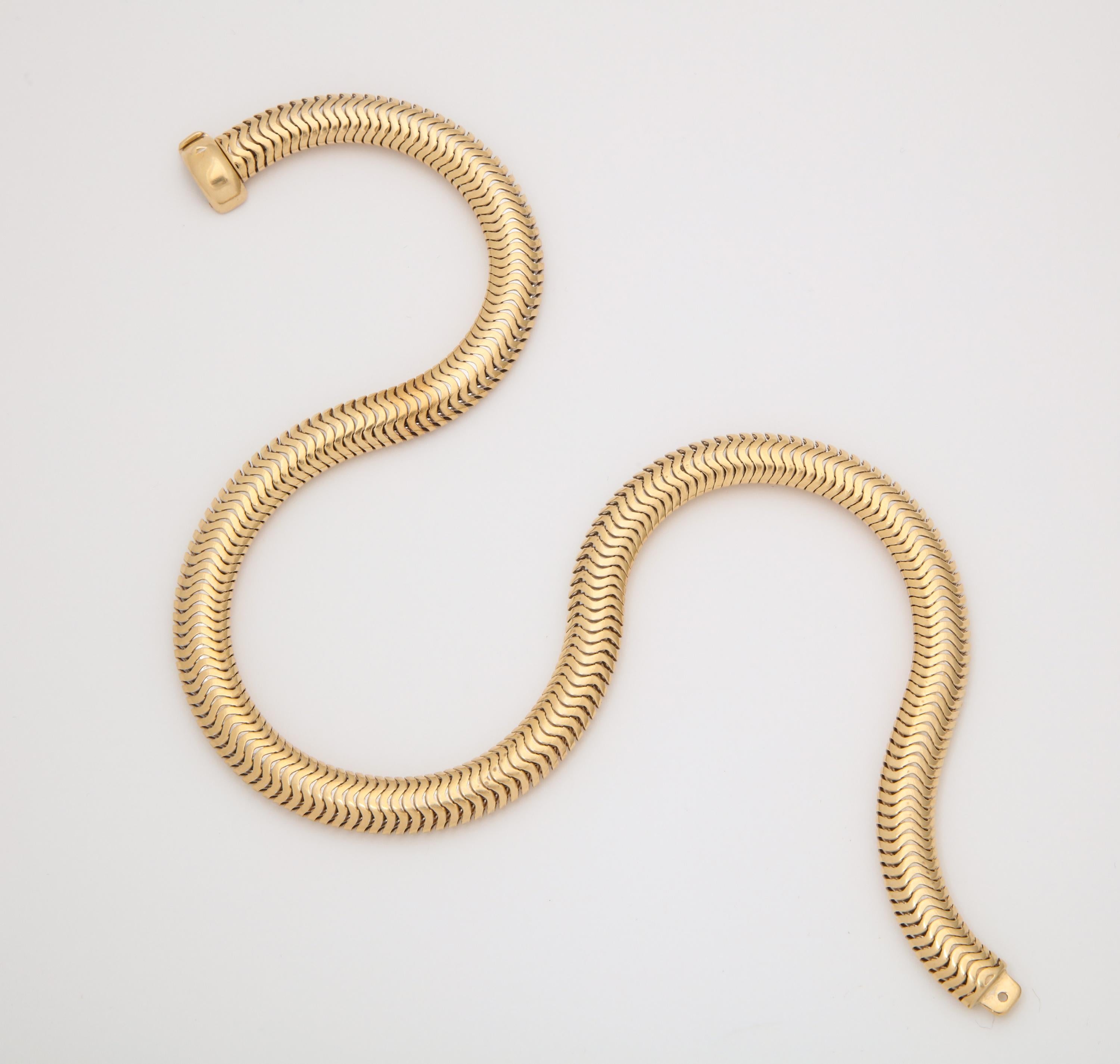 One 14kt Flexible Gold Snake Style Omega Link Necklace With 14kt Gold Lock Clasp Which May Be Worn In Front Or The In The Back.Circa 1940's Made In The United States Of America,Length 16.5 Inches.