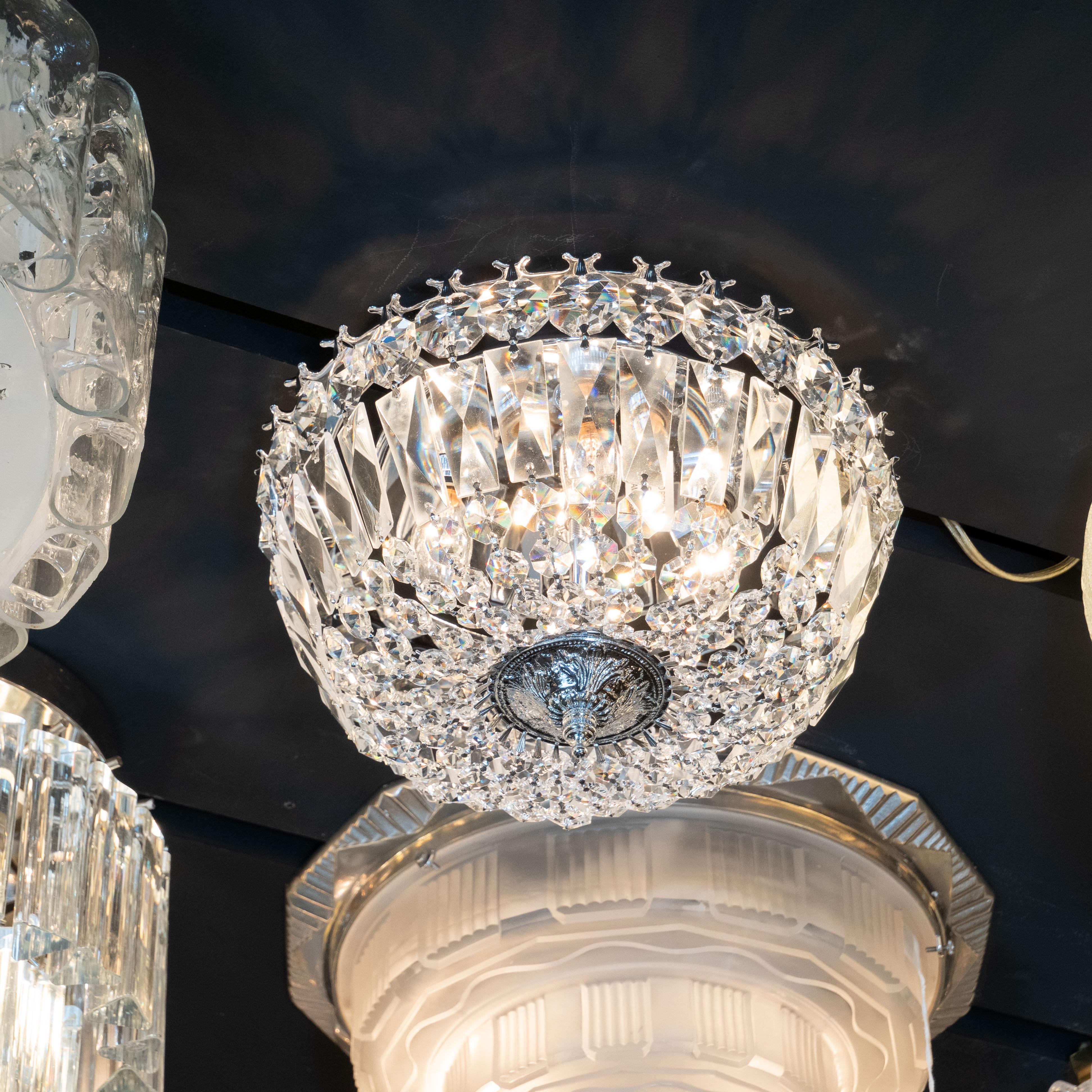 This elegant and glamorous Hollywood Art Deco flush mount chandelier was realized in the United States, circa 1945. It features an abundance of faceted crystal medallions- resembling finely cut and luminous diamonds- attached to a silvered frame.