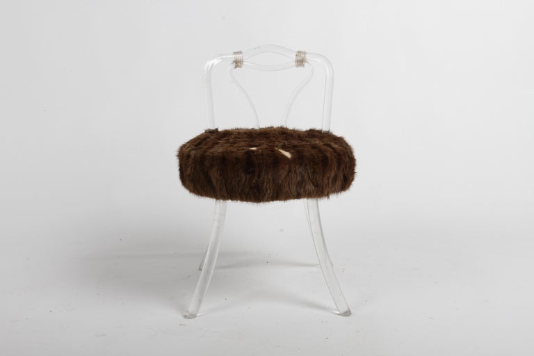 Hollywood Regency or 1940s glamour low swivel vanity chair or stool with faux fur on splayed legs. Twisted and bent lucite in the style of Dorothy Thorpe or Lorin Jackson for Grosfeld House. Lucite shows wear, some light scuff , faux fur has loss,