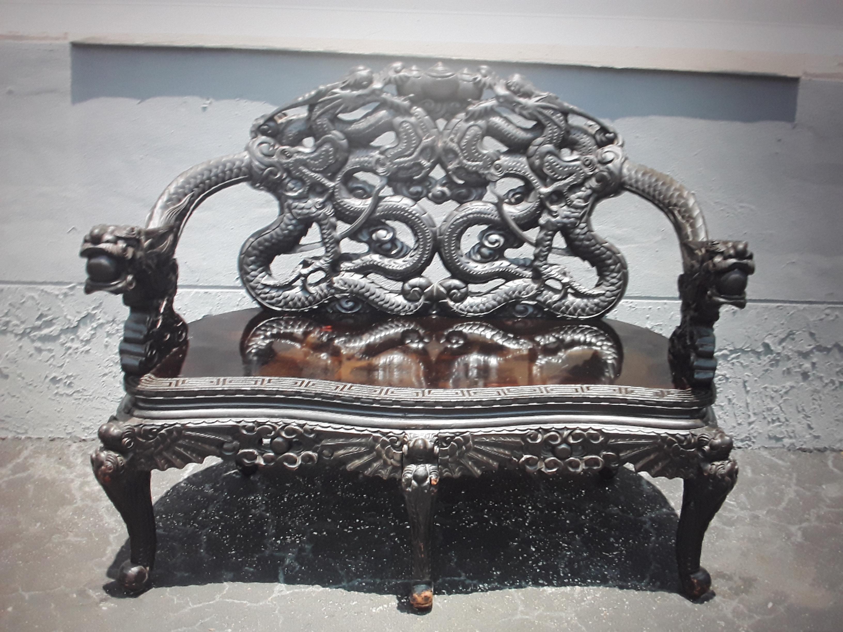 c1940's Chinoiserie/ Asian Carved and Ebonized Wood Sitting Bench. Amazing carving. Please look closely at pictures as they tell the details of the carvings.