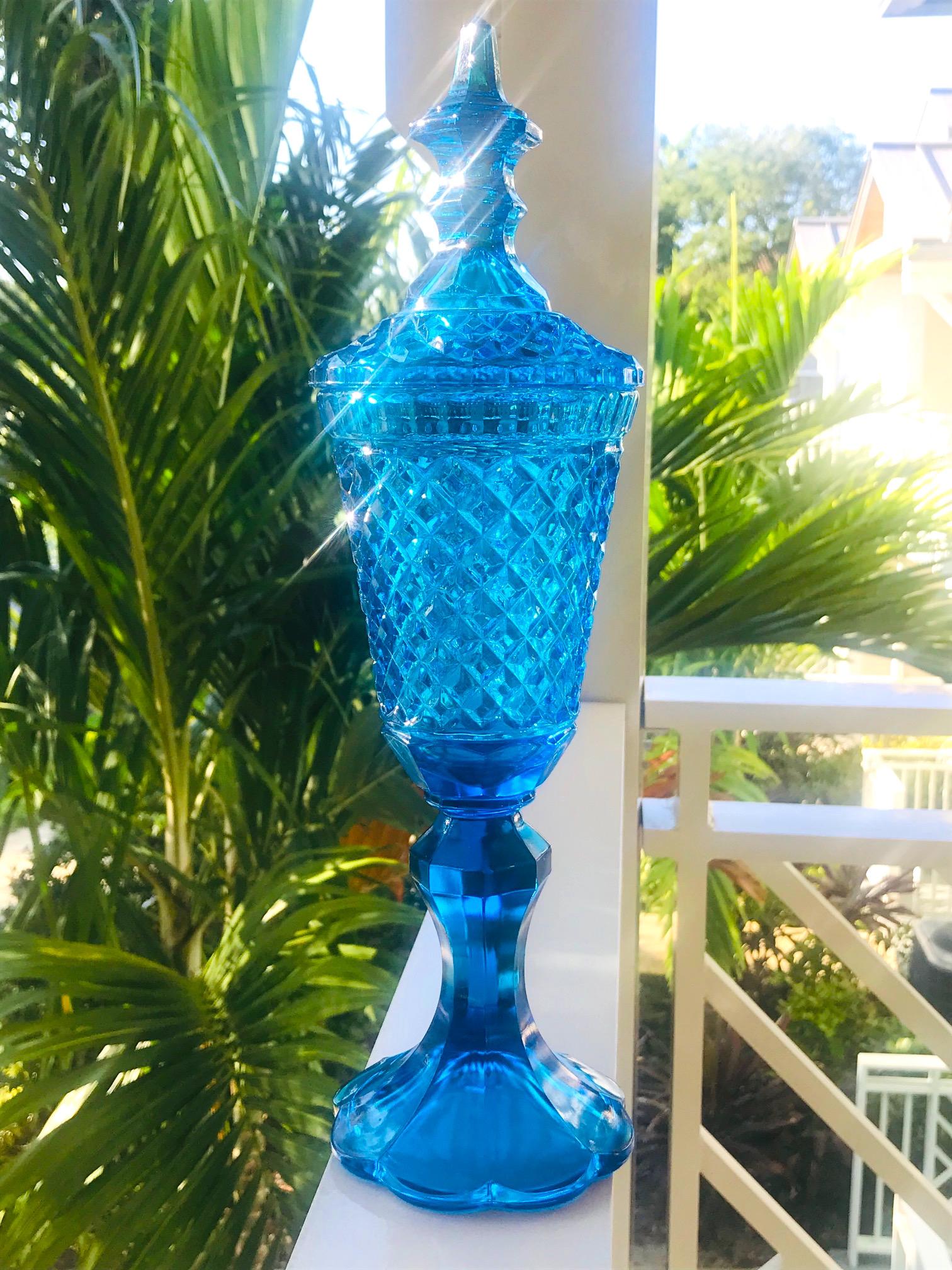 Mid-Century Modern footed glass apothecary jar or urn with stylized lid. In gorgeous hues of aqua or turquoise, this chic vase features faceted glass edges with diamond cut spikes throughout, and with a curved fluted base. Great alternative to a