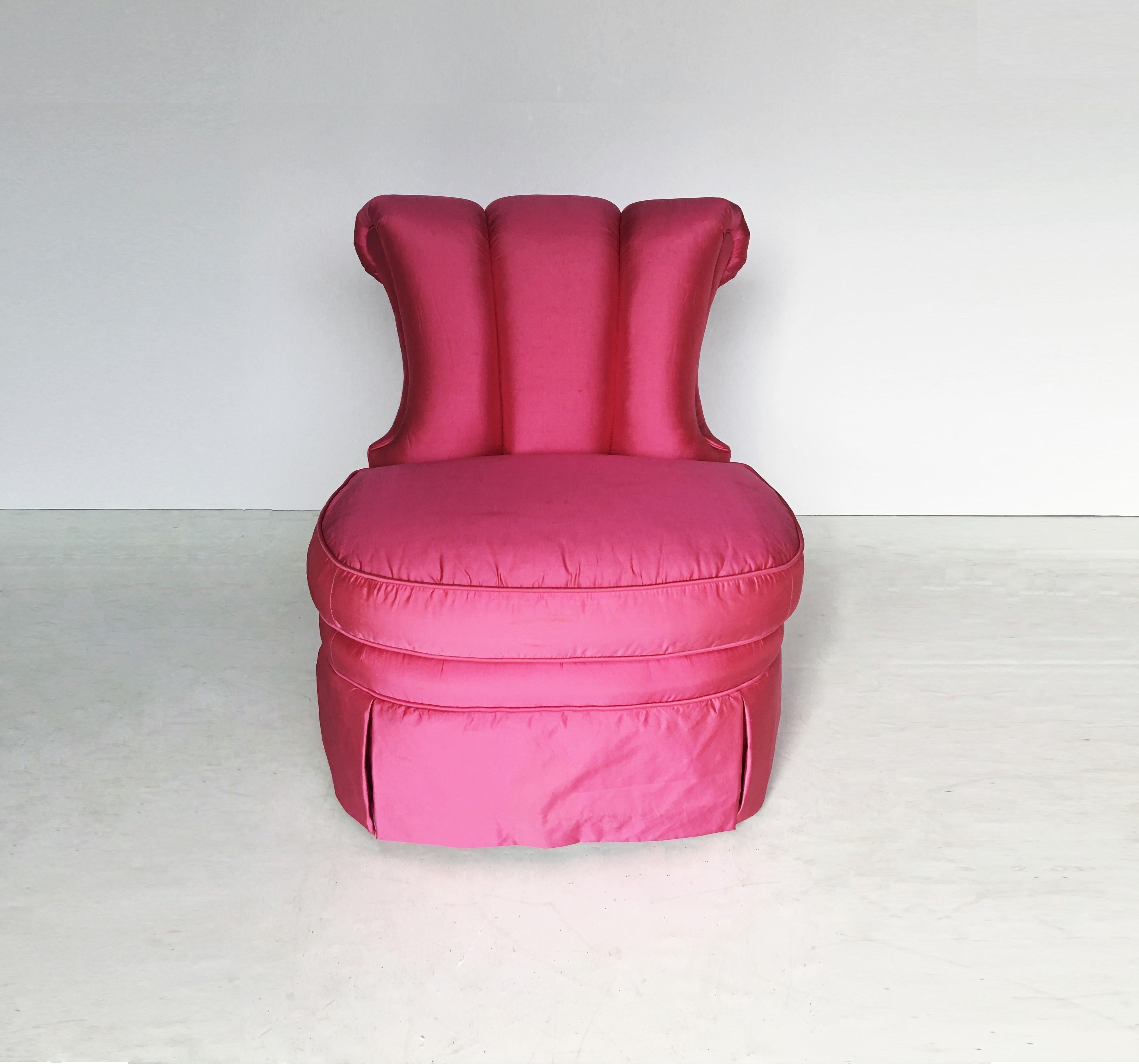 This elegant slipper chair was designed by the celebrated 20th century visionary Dorothy Thorpe, in the United States, circa 1940. It features a channel back with a stylized cresting scroll form at its apex, and rectangular ebonized walnut legs. The