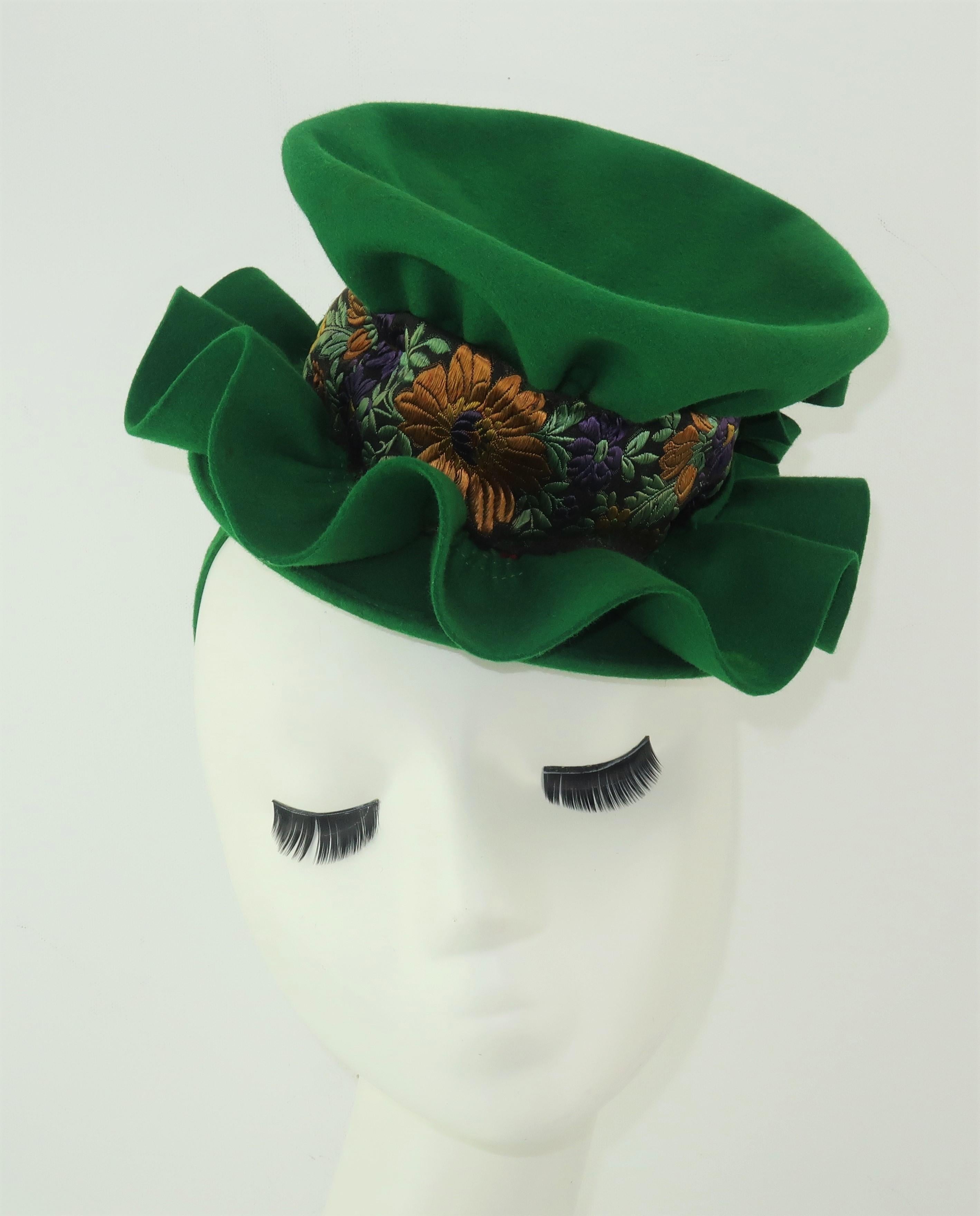 A fabulous G. Howard Hodge green wool felt hat with an eye catching design that includes a wavy brim, double bows and a rich brocade ribbon trim incorporating shades of goldenrod, purple, sage green, red and black.  The tilt silhouette is easily