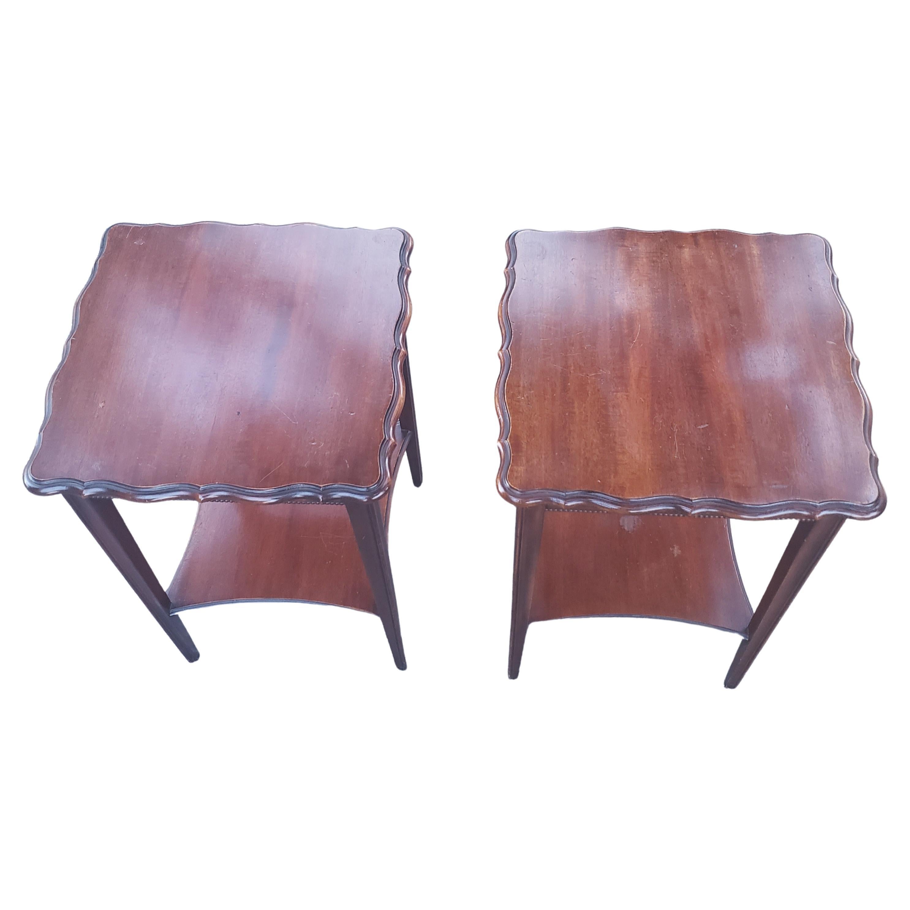 Rare pair of two-tier side tables in solid mahogany with scallop edge with rope detail by Imperial furniture. Measures 17