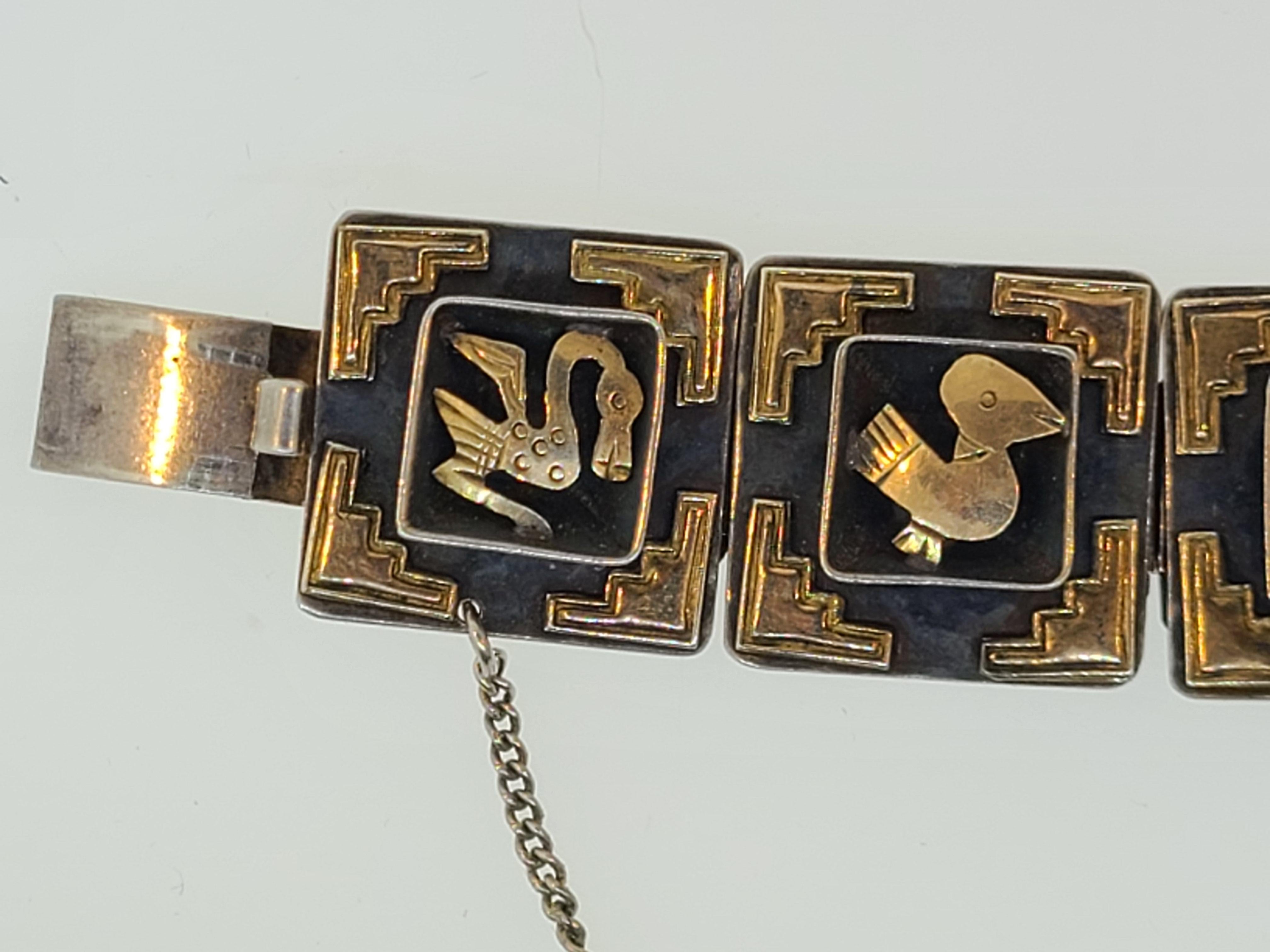 This estate found 1940's panel bracelet is made of sterling silver and embellished with 18K yellow gold Inca designs. Signed Cuzco this Peruvian made bracelet is a wonderful example of their handcrafted jewelry. The Bracelet is 7 inches long from