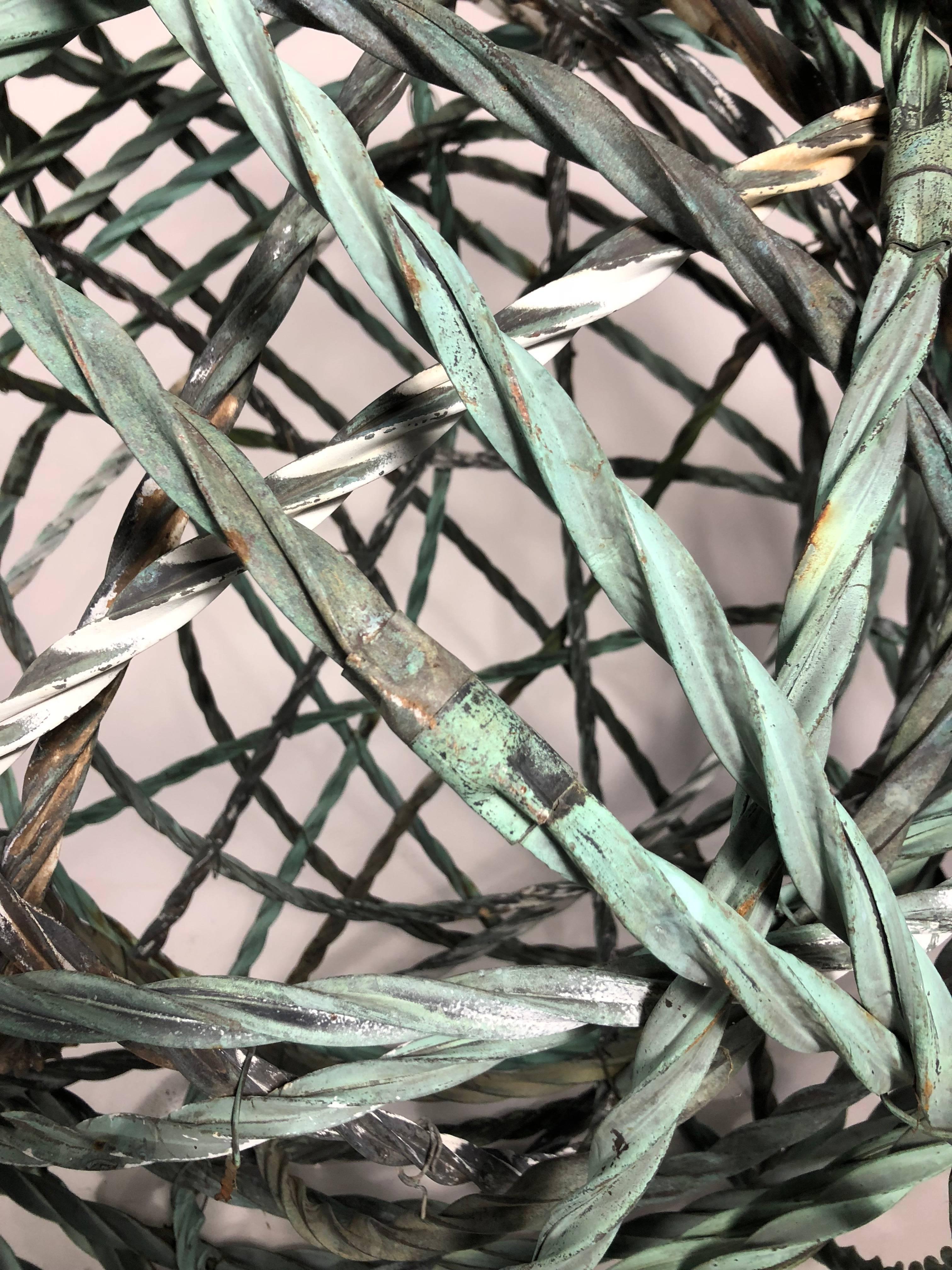 Copper wrapped cable with original green patina. Serves as a decorative piece for both the yard and indoor space.