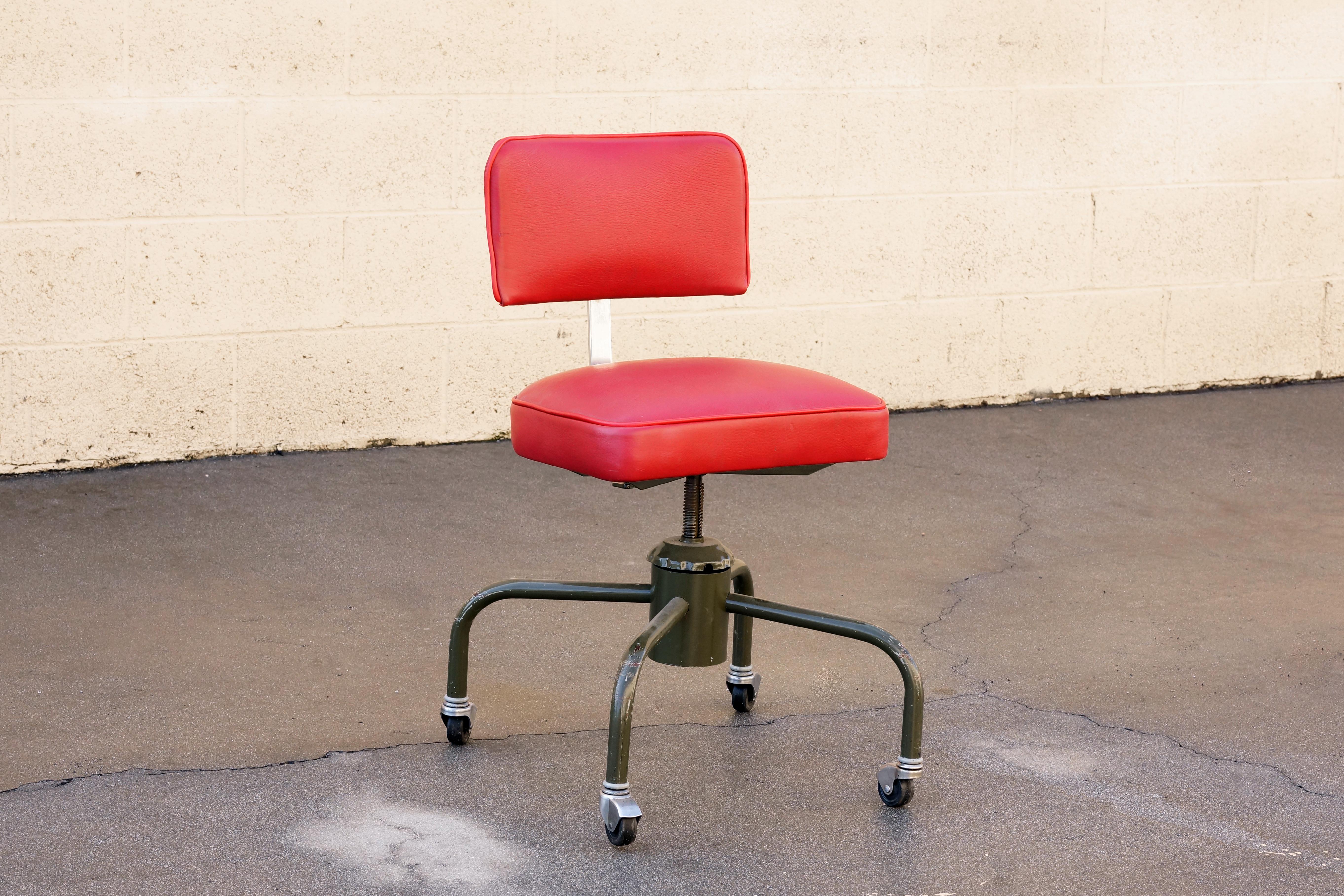 We refinished this 1940s industrial drafting stool in quality deerskin leather and left the original army green paint intact. This iconic seat swivels, rolls on casters and height adjusts. 

Dimensions: 18