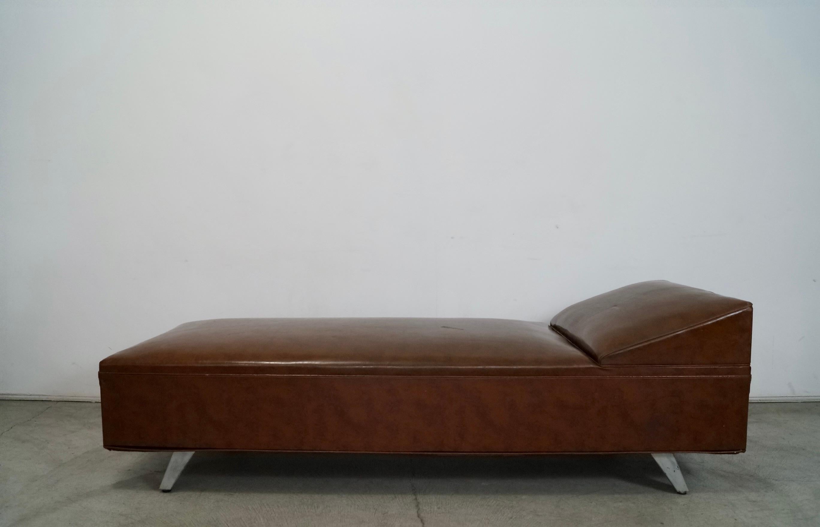 Vintage original Midcentury Modern daybed for sale. From the 1940's, and manufactured by Royal Metal Manufacturing Company with the original label still intact. It has the original tan naugahyde vinyl. It's in overall good condition with some