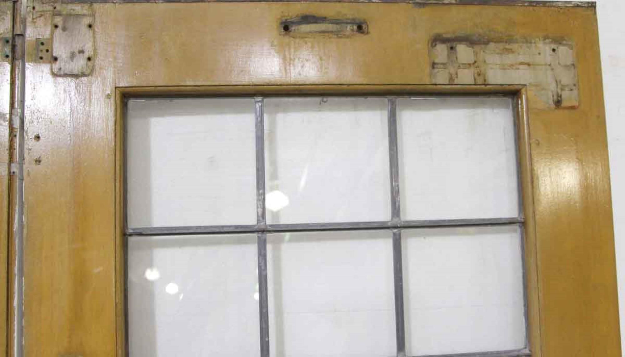 1940s Industrial commercial pair of doors with nine leaded lites each. The doors are painted white on one side and are a medium wood tone on the opposite side. Priced as a set. This can be seen at our 400 Gilligan St location in Scranton, PA.
