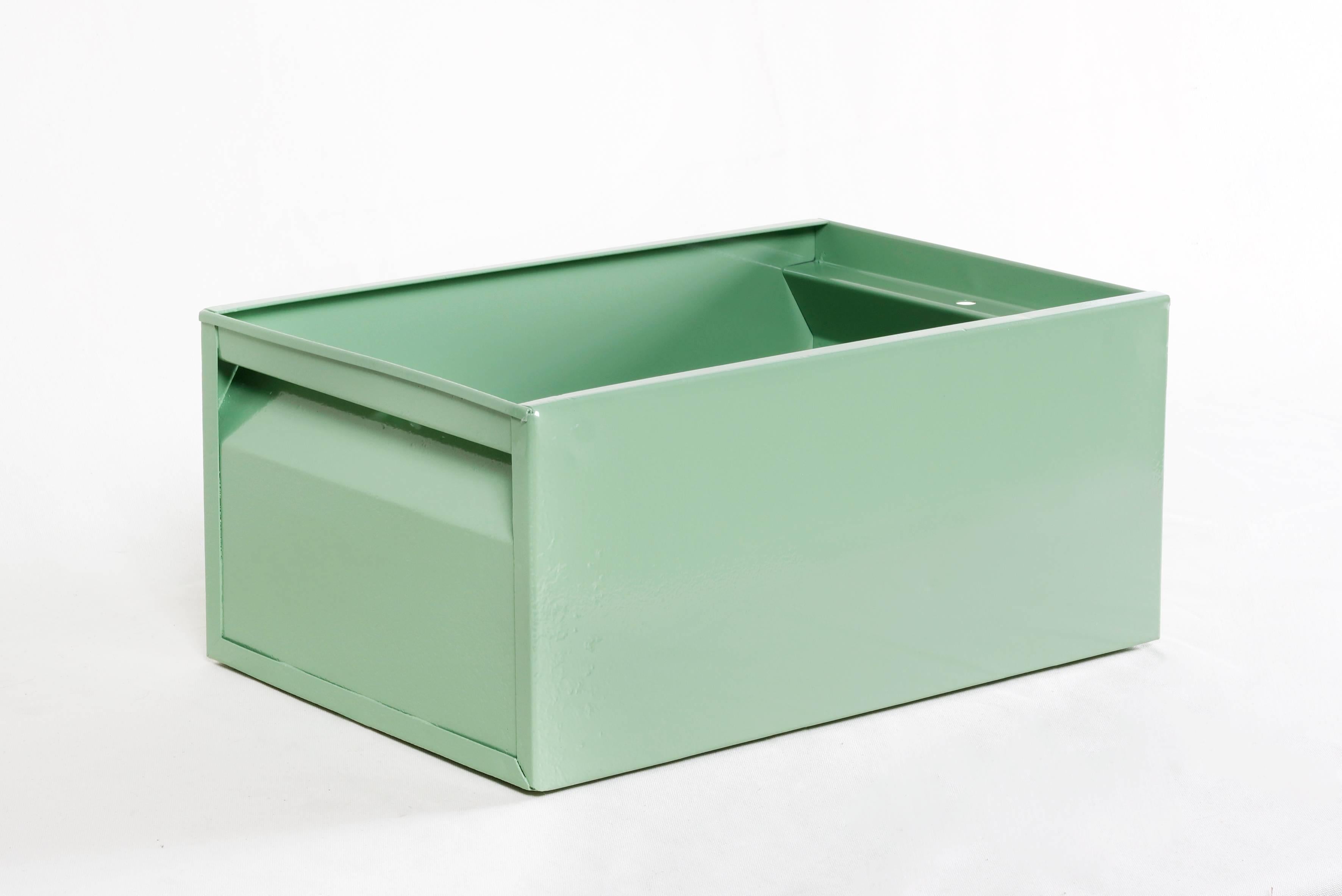 We refinished this fantastic 1940s Industrial storage bin in a gloss Sage Green powder coat. Perfect for storing just about anything from office supplies and tools to reading material. This heavy-duty steel organizer is sure to keep your workplace