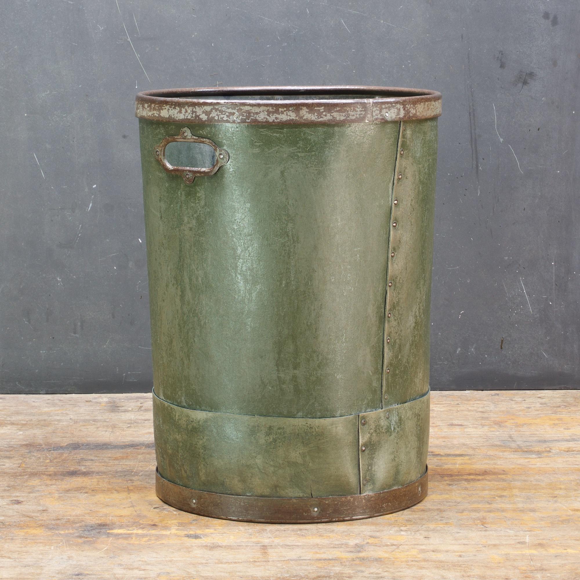 Large Industrial waste bin for office/home use. Riveted green wastebasket/trash-can made in Long Island City New York. Rim, handle and bottom are metal, good weight, heavy fibre material.
