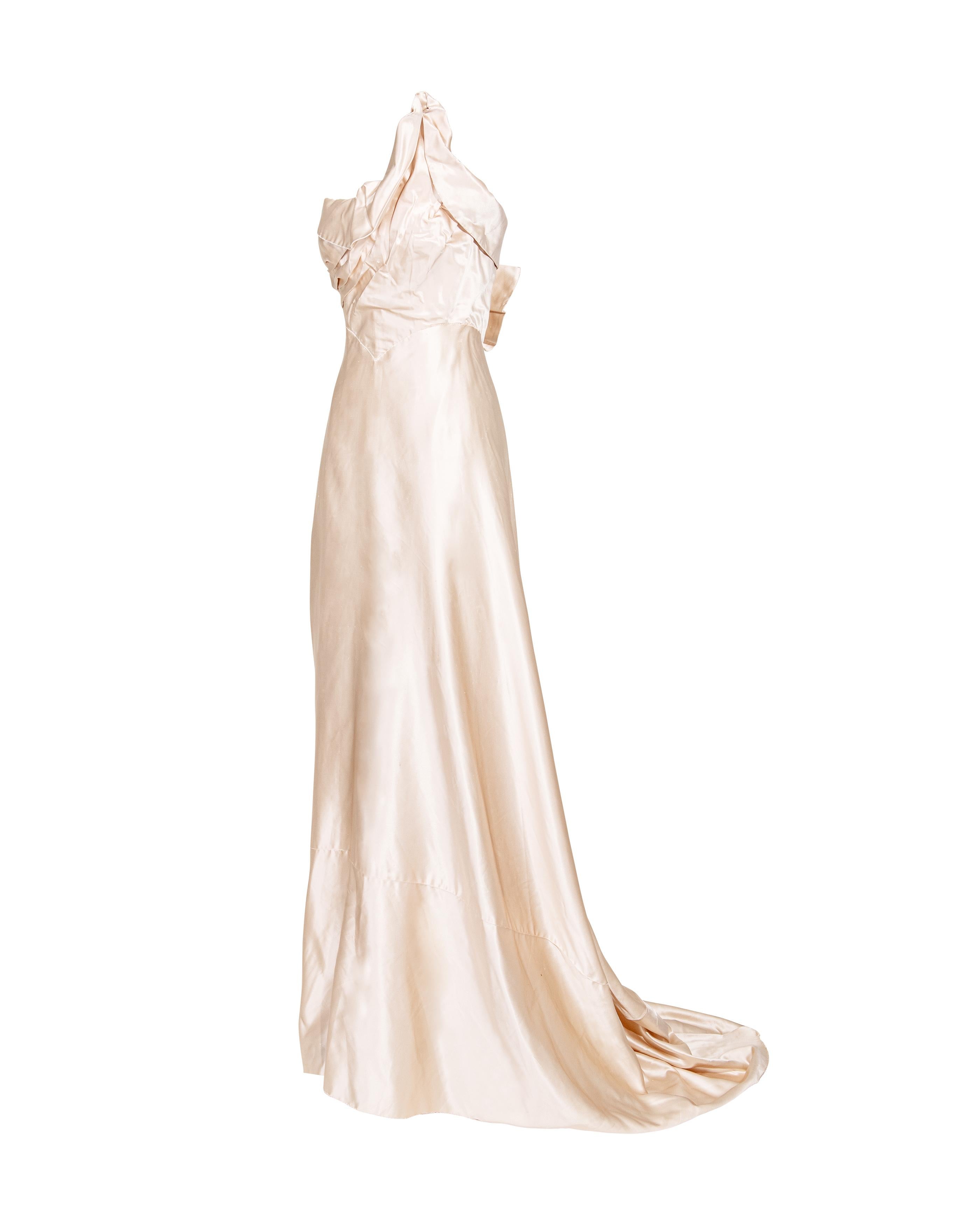 1940's Irene Lentz Haute Couture strapless high-low silk gown. Sculptural style cream silk gown that features deconstructed pleating and asymmetrical point at left side bustier. High-low effect with midi length front and long hem with slight train.