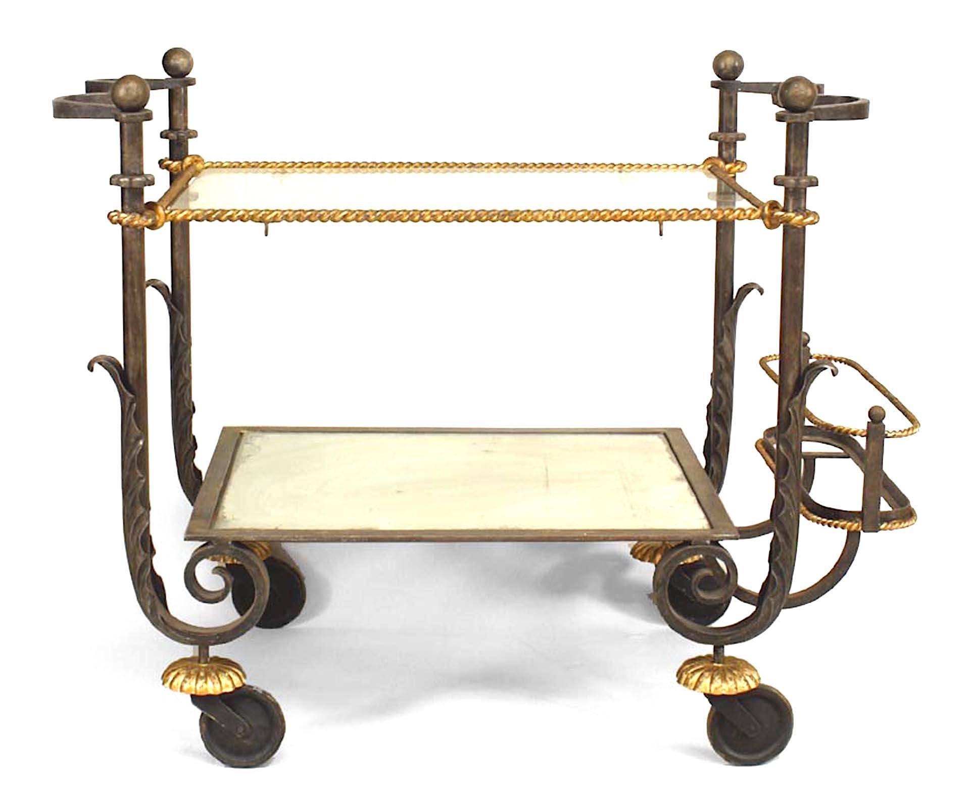 1940's two tier tea cart attributed to the French designer Gilbert Poillerat. The iron and gilt rope style cart features two glass shelves, a rear bottle rack, and rests on wheels.

The French decorator and wrought iron craftsman Gilbert Poillerat
