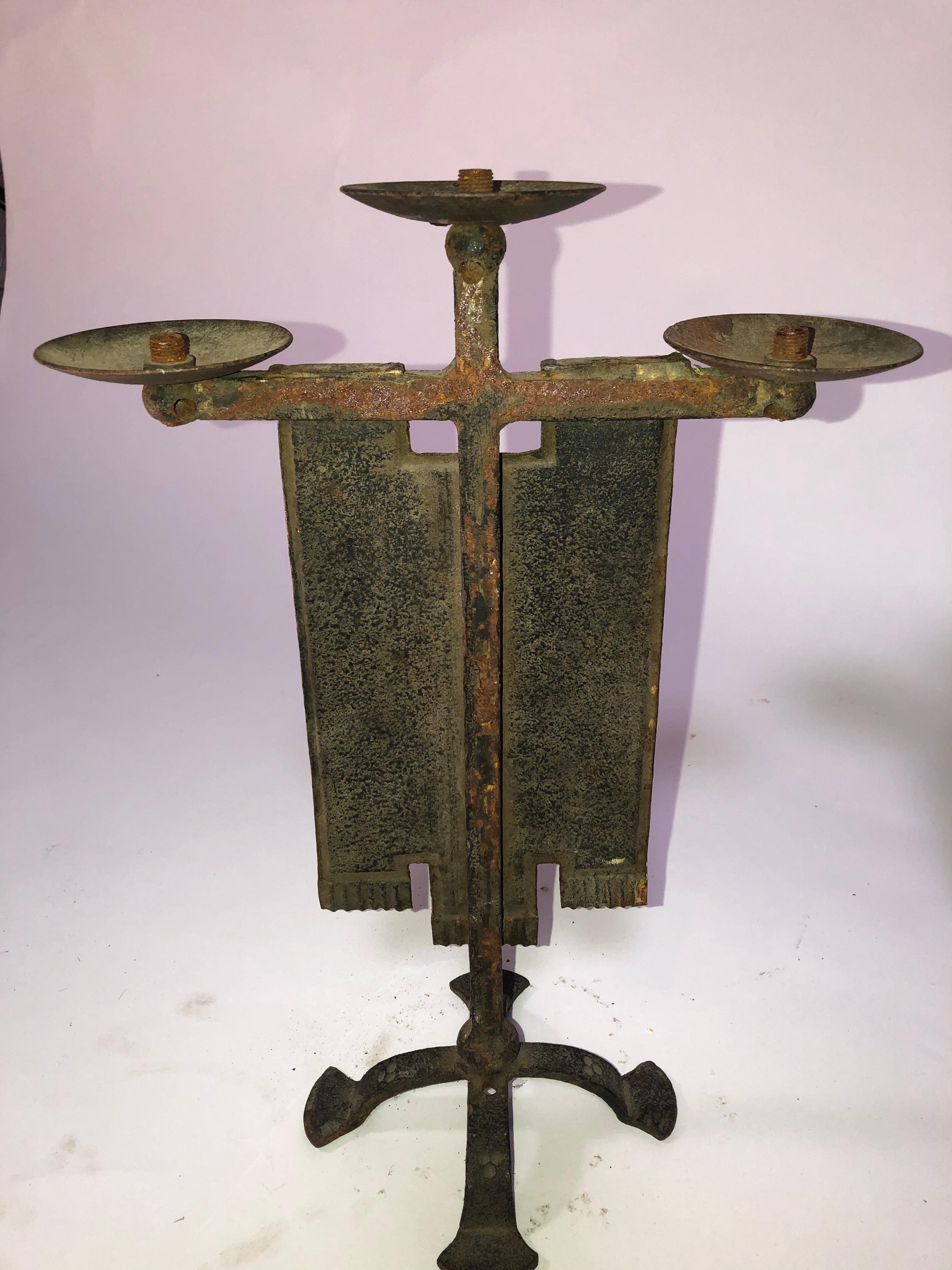 1940s French iron candelabra with hand painted ceremonial emblems. It needs to be wired.