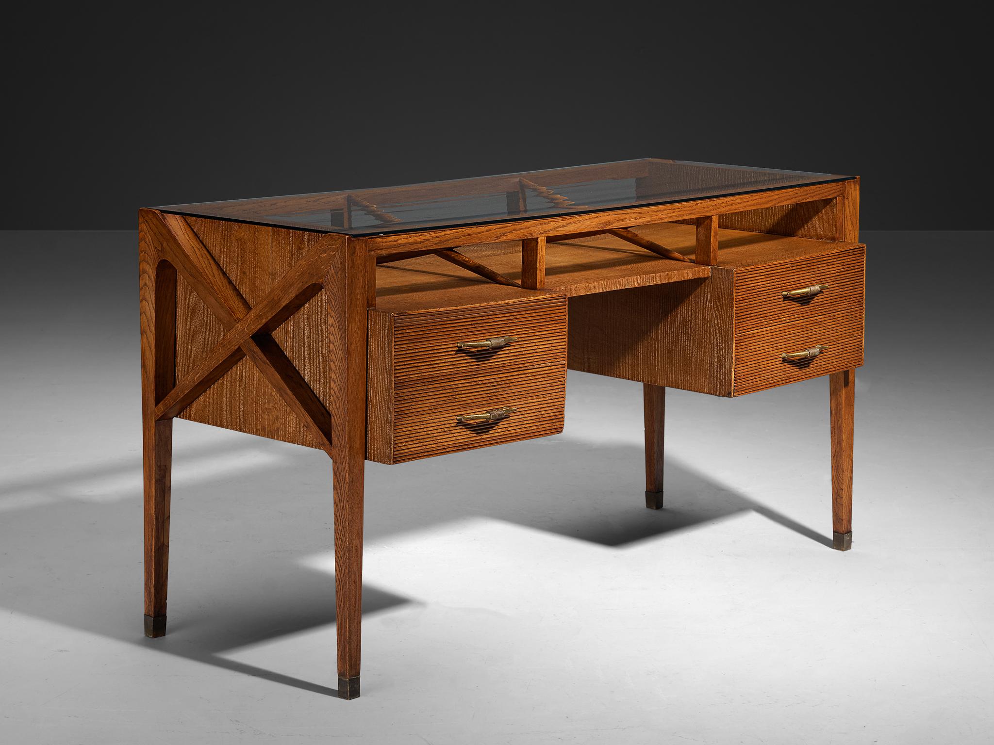 Writing desk, oak, brass, glass, Italy, 1940s

This exquisite writing table, a creation of Italian Art Deco design, dates back to the 1940s. Crafted by a skilled Italian artisan, it stands out for its sophisticated form, exceptional use of
