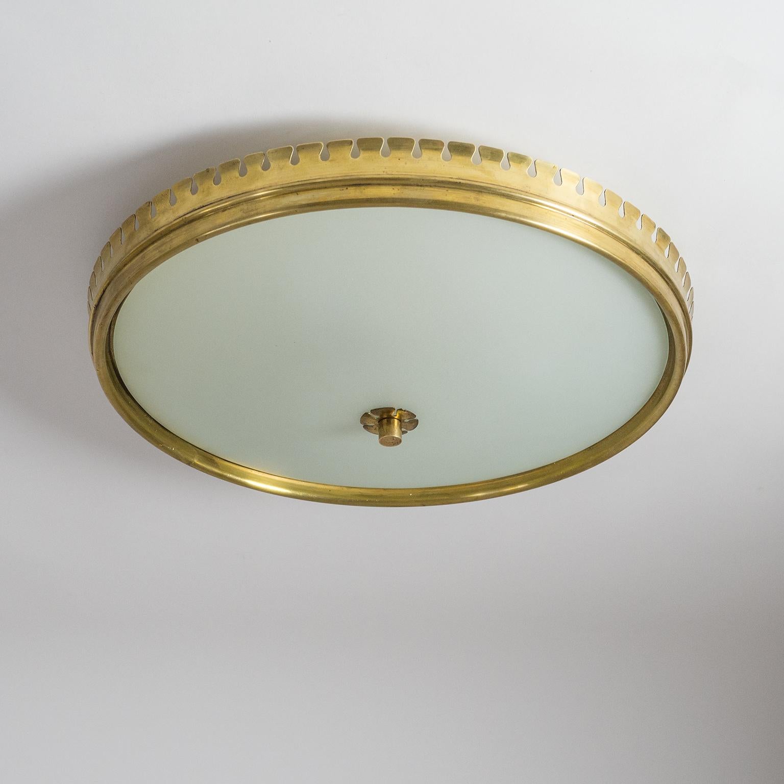Beautiful Italian brass and satin glass flush mount from the 1940s attributed to Paolo Buffa. The main structure is constructed entirely of brass (lacquered an off-white on the inside) with a lovely sculpted and very uniquely scalloped rim. The back