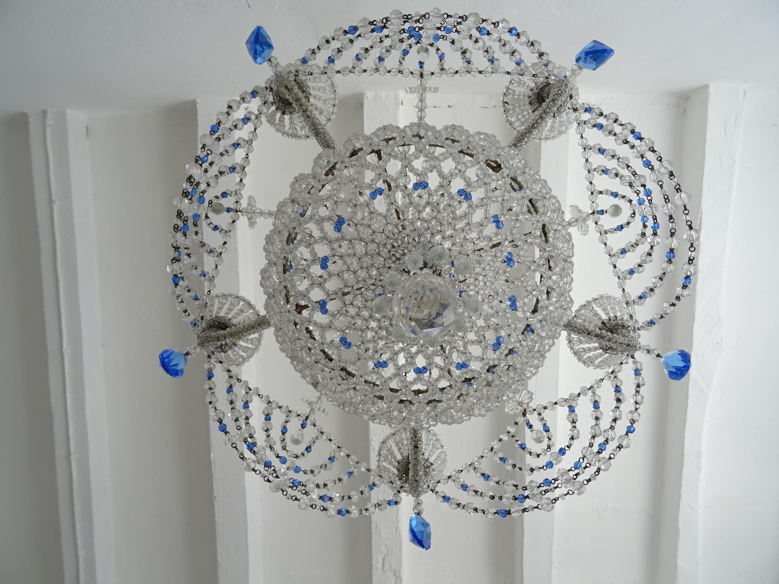 Housing 5 lights in beaded cups. This elegant chandelier is completely beaded with a beaded lace bottom. Adorning rare cobalt blue crystal prisms and cobalt blue beads throughout. Swags of crystal clear beads and cobalt as well. Spears on bottom