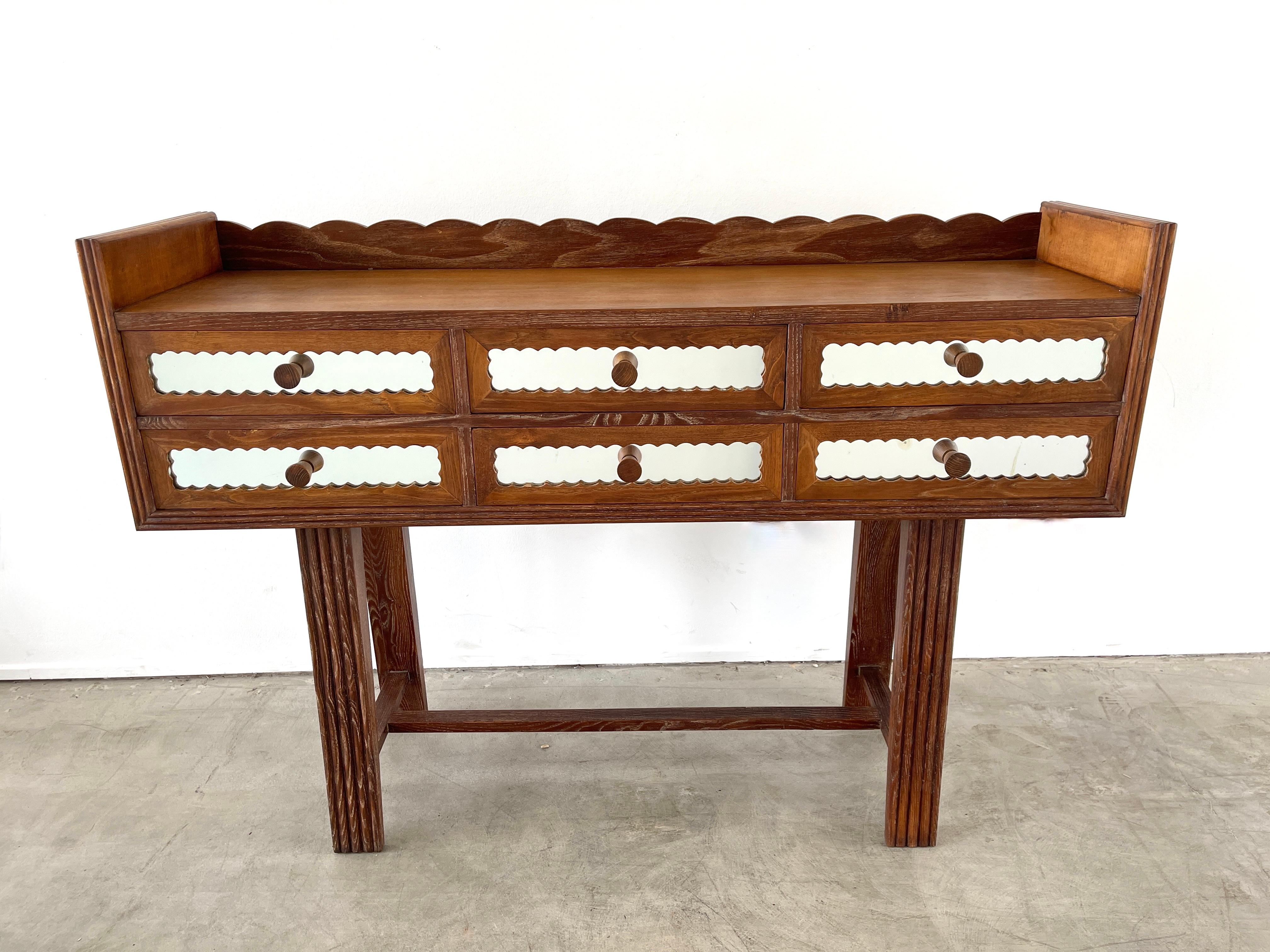 1940's Italian mirrored console with scalloped detail, carved edges and mirrored drawer fronts. 
Incredible piece.
